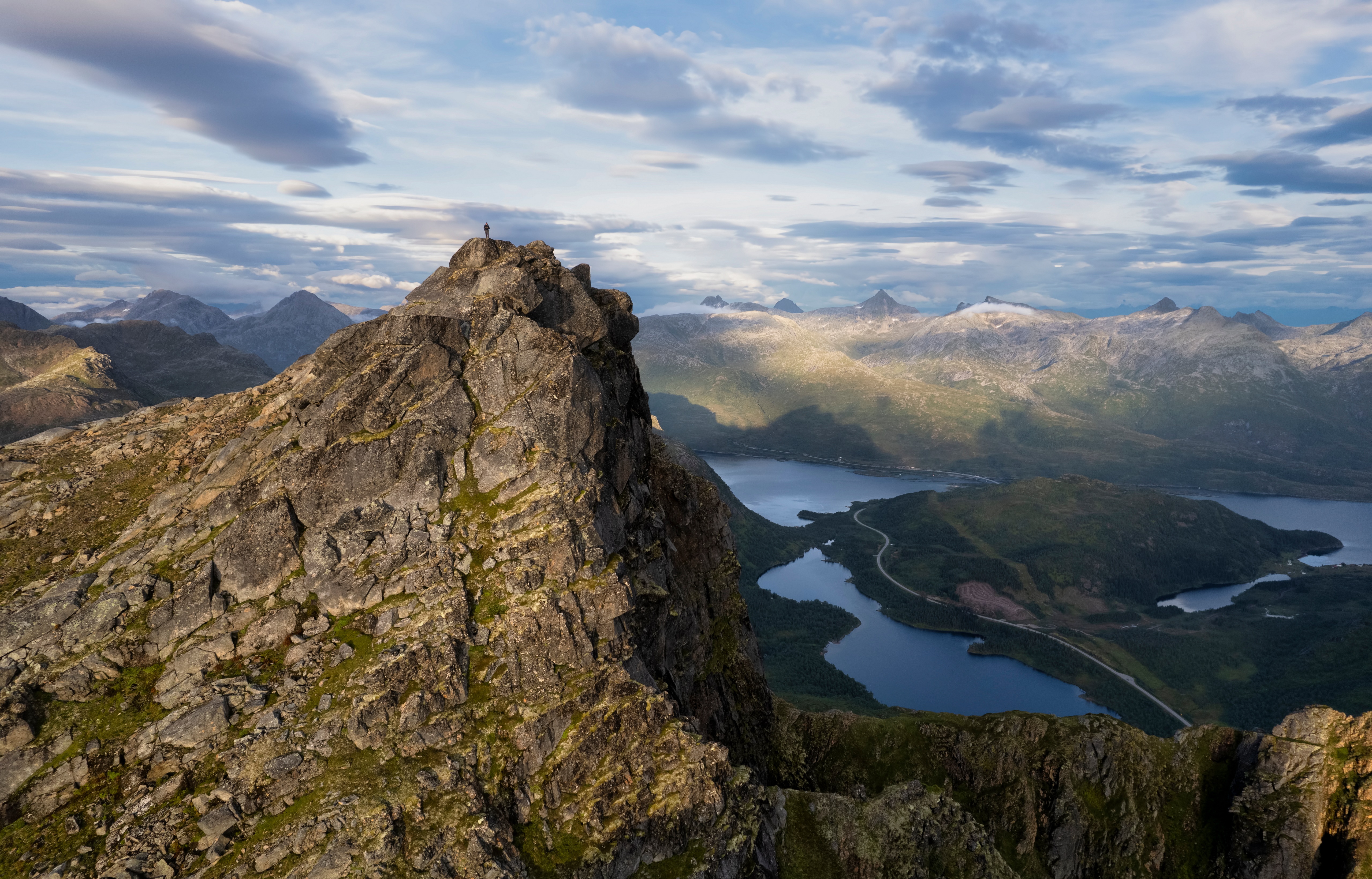 Man on Myrland mountain peak in Lofoten, Norway HD Wallpaper