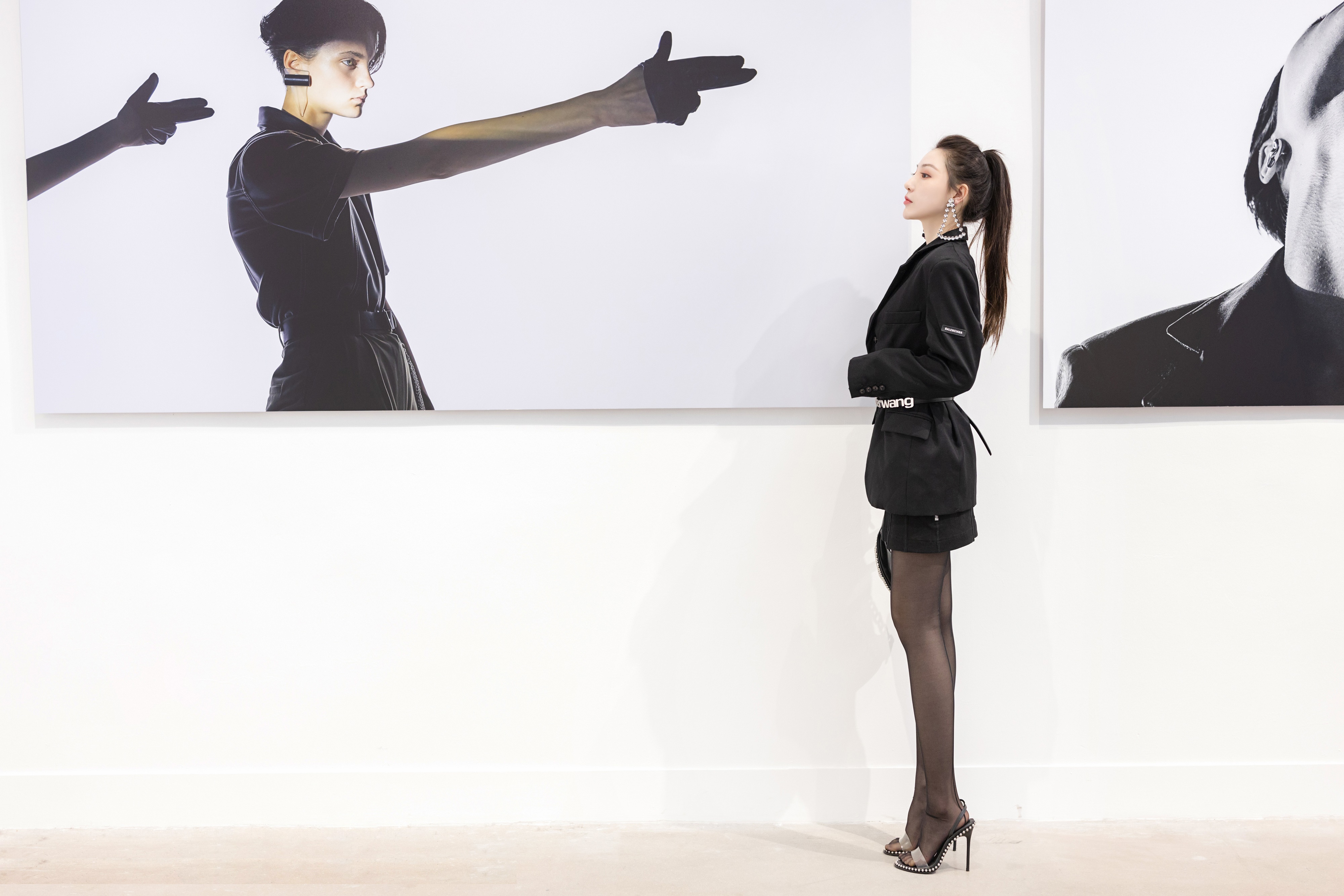 Woman in black blazer looking at art HD Wallpaper