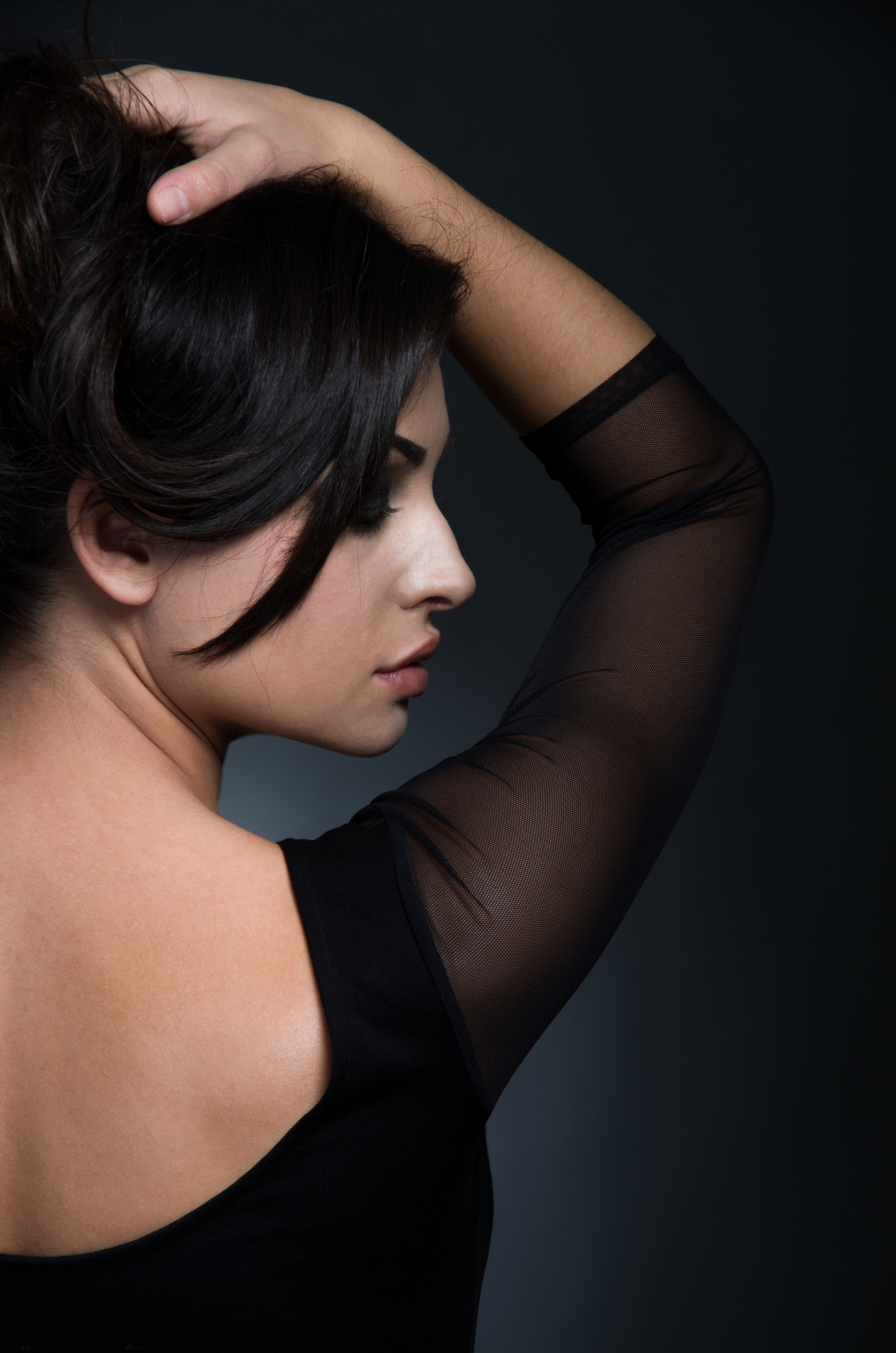 Brunette woman with hand in hair, back view HD Phone Wallpaper