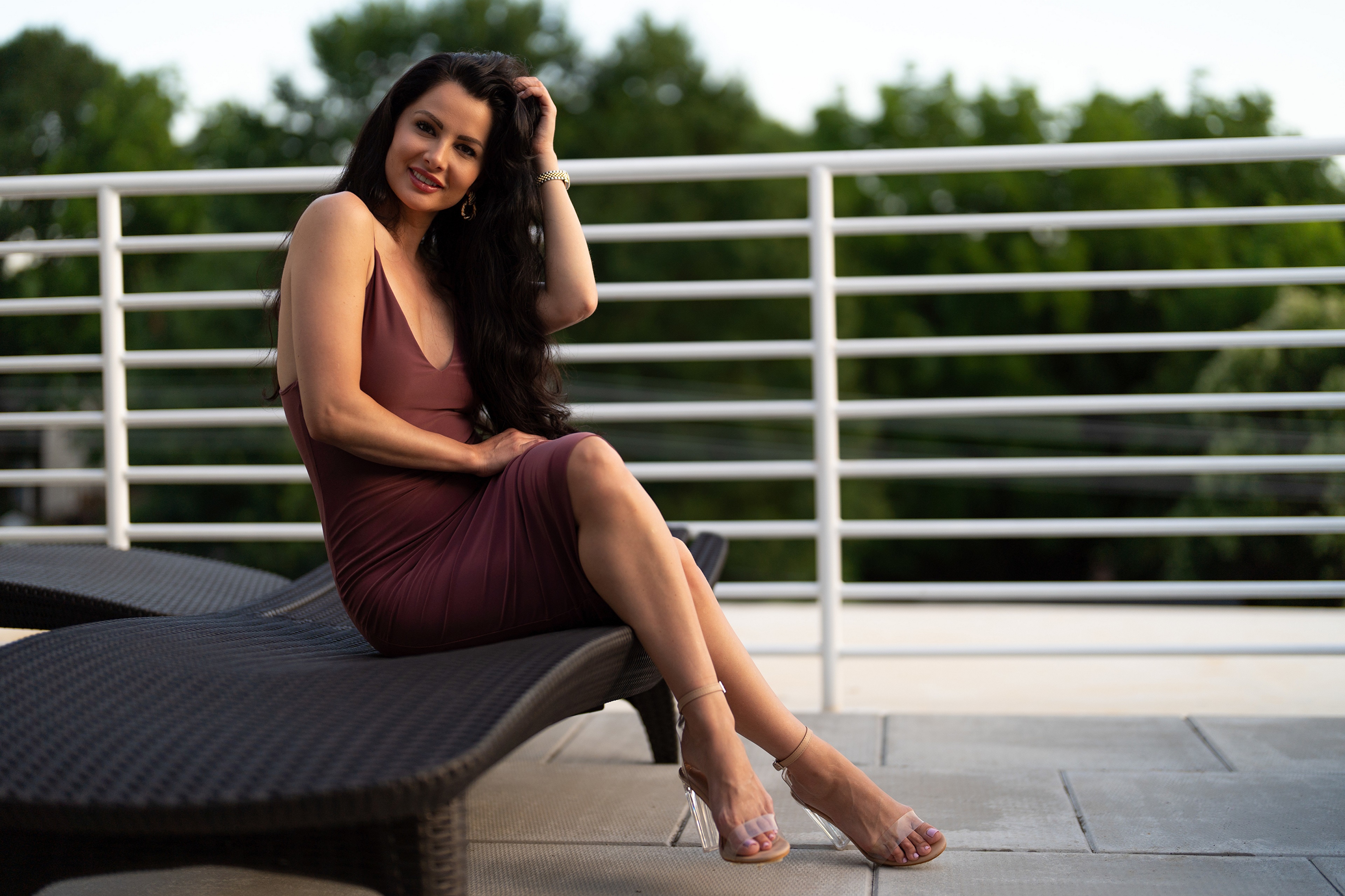Victoria Bell sitting on a lounge chair HD Wallpaper