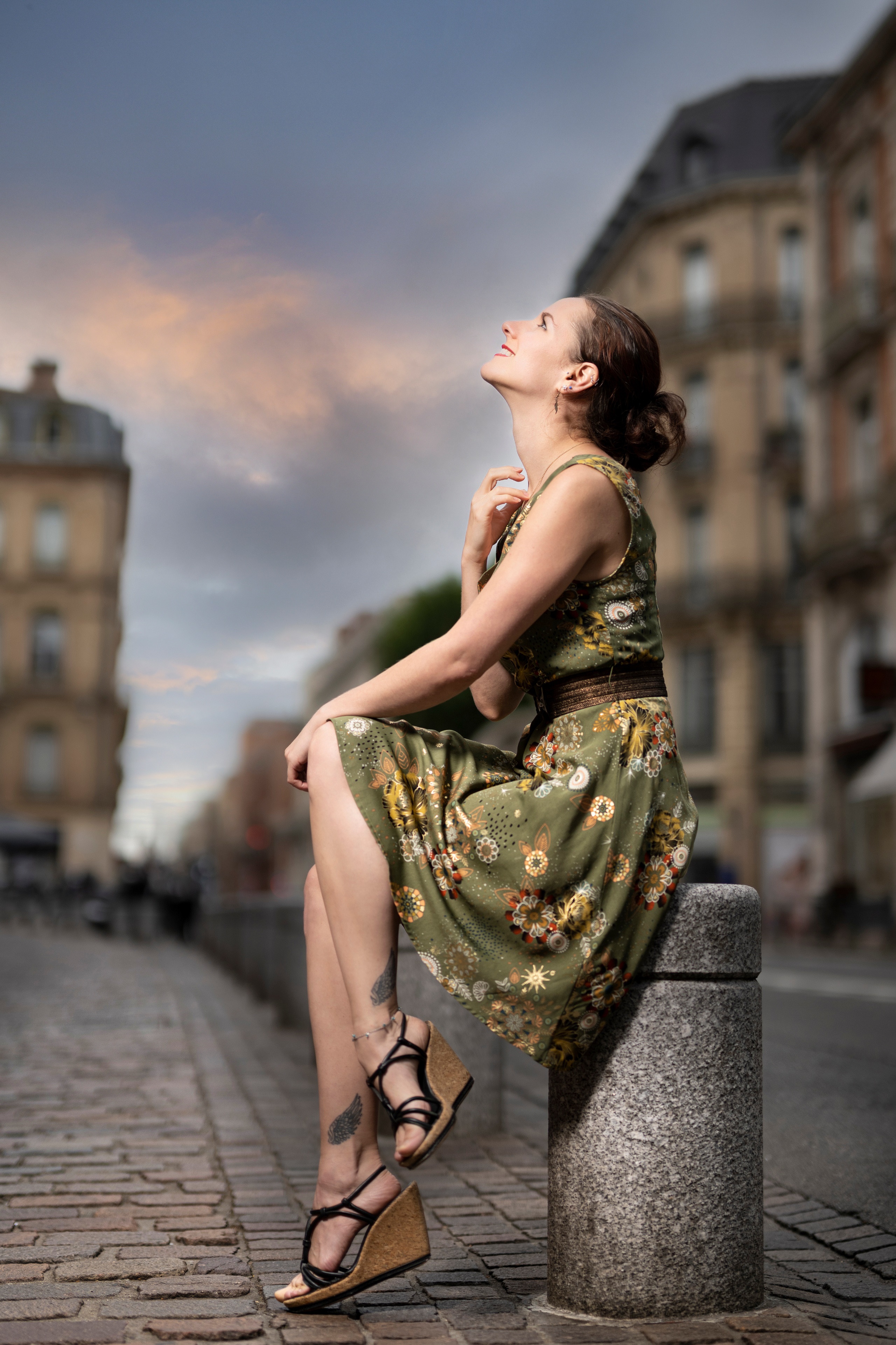 Woman in a floral dress sitting on a stone bollard HD Phone Wallpaper