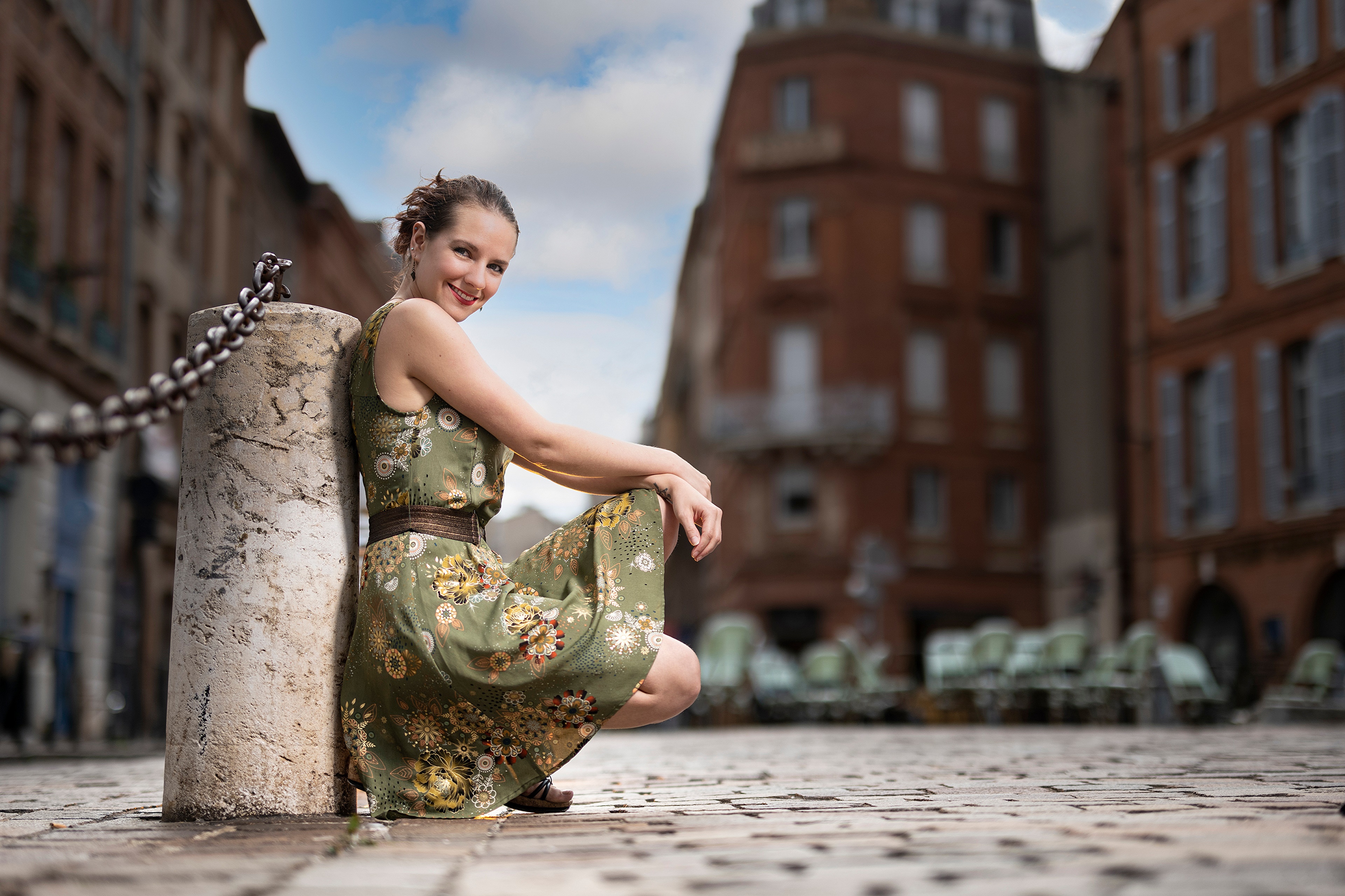 Woman in a green dress posing outdoors HD Wallpaper
