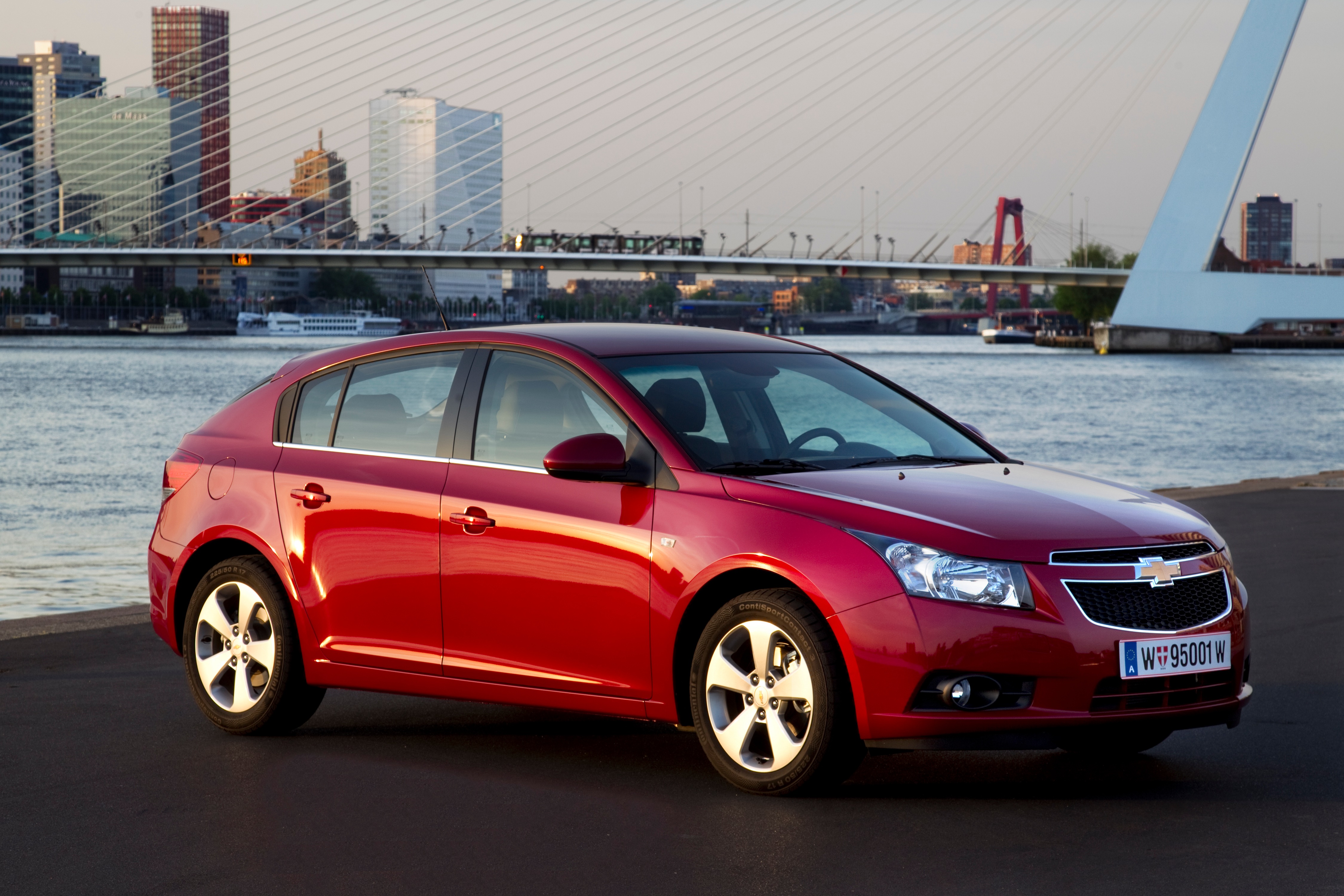 Red Chevrolet Cruze Hatchback by a River HD Wallpaper