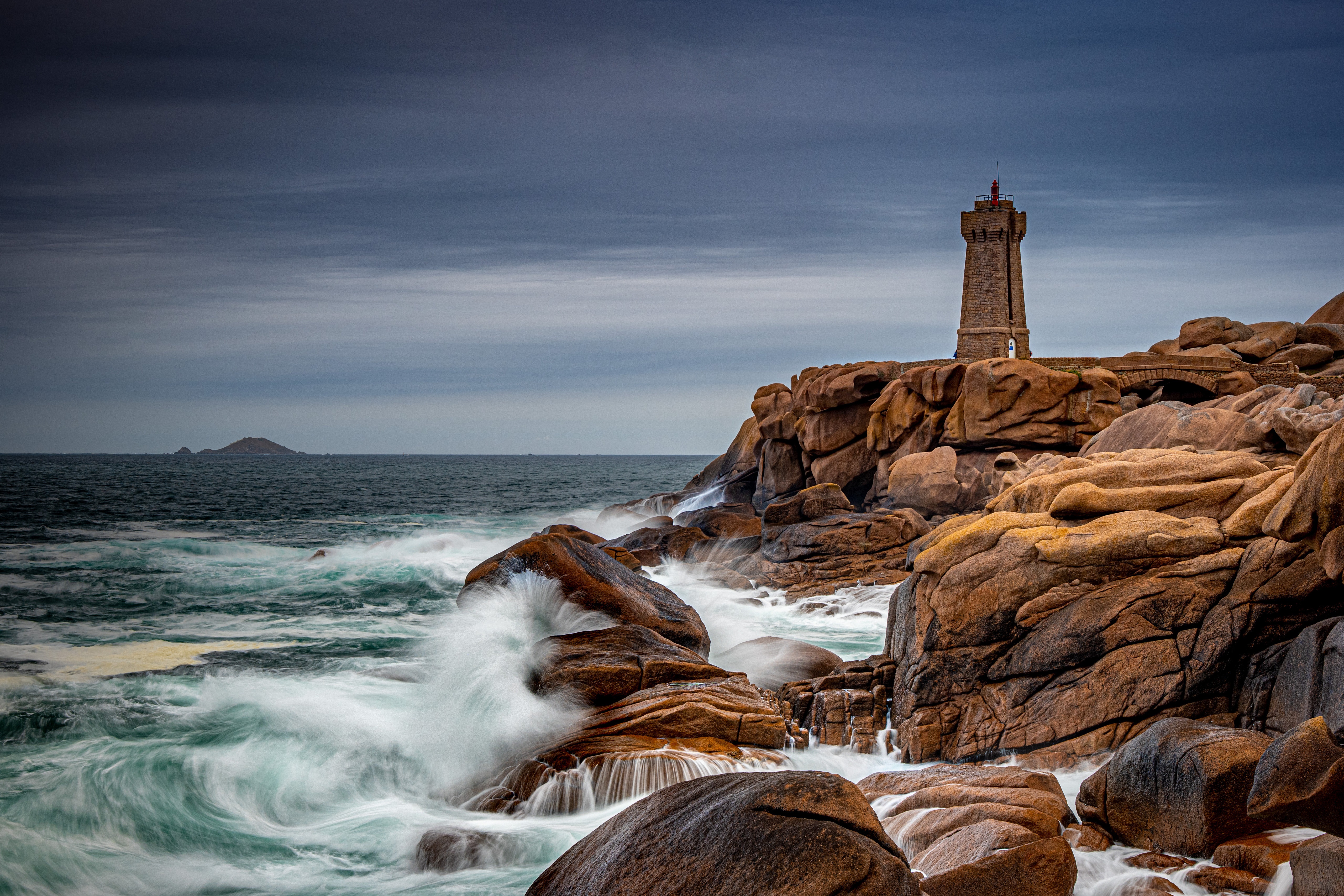 Lighthouse on rocky coast in Ploumanach, France HD Wallpaper