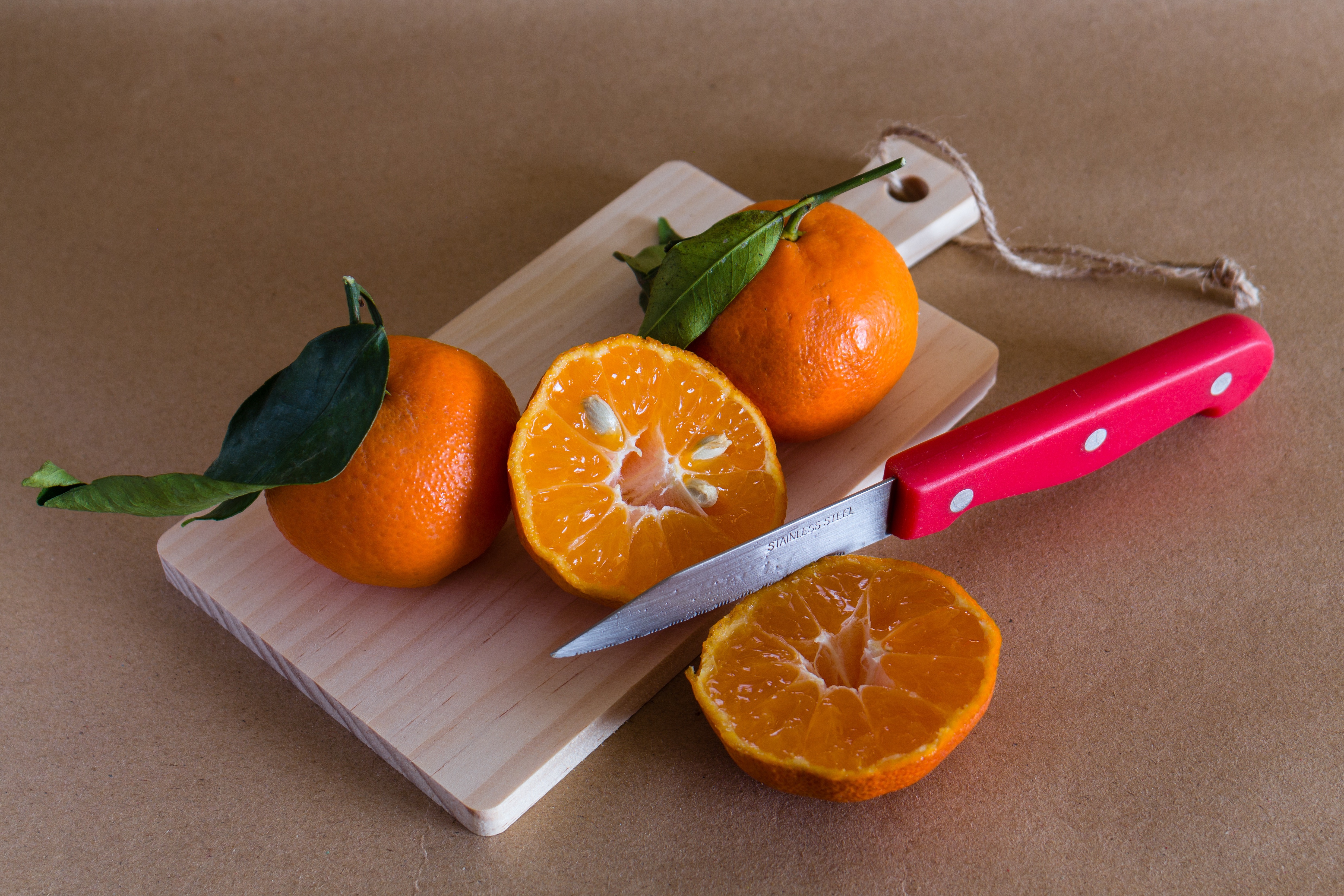 Mandarins on a cutting board with a knife HD Wallpaper