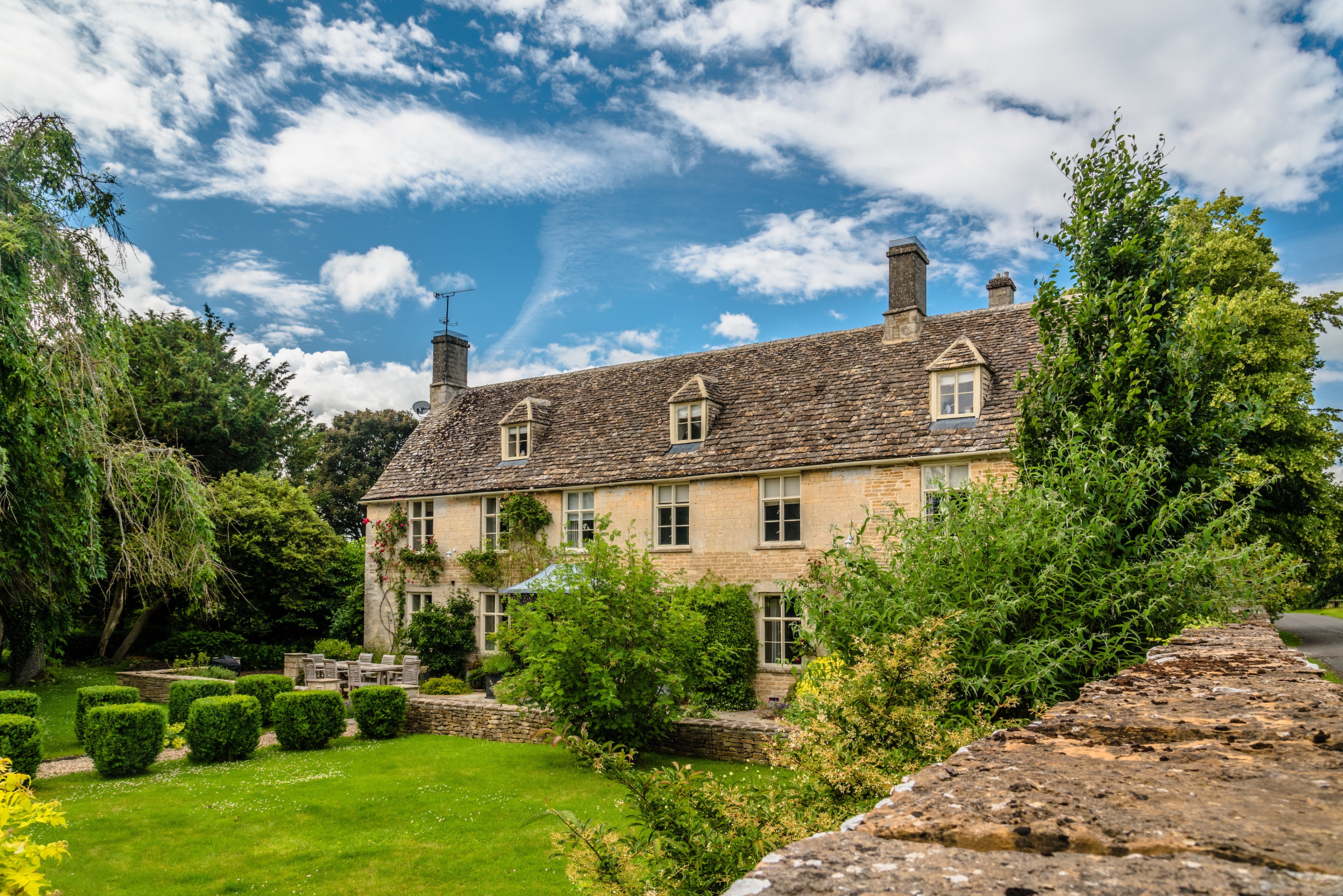 Stone house with dormer windows and garden in England HD Wallpaper