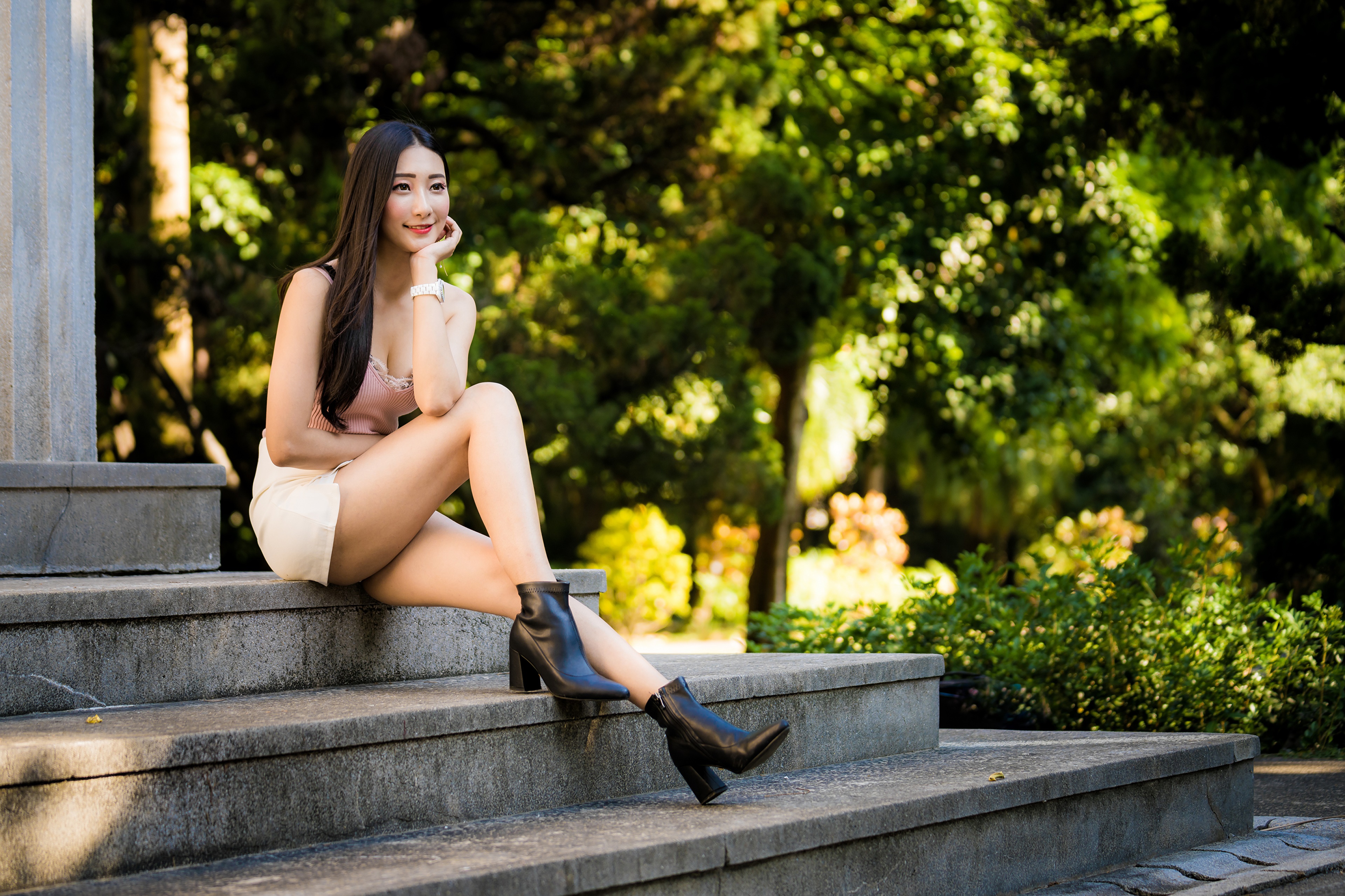 Asian woman sitting on stairs in a park HD Wallpaper