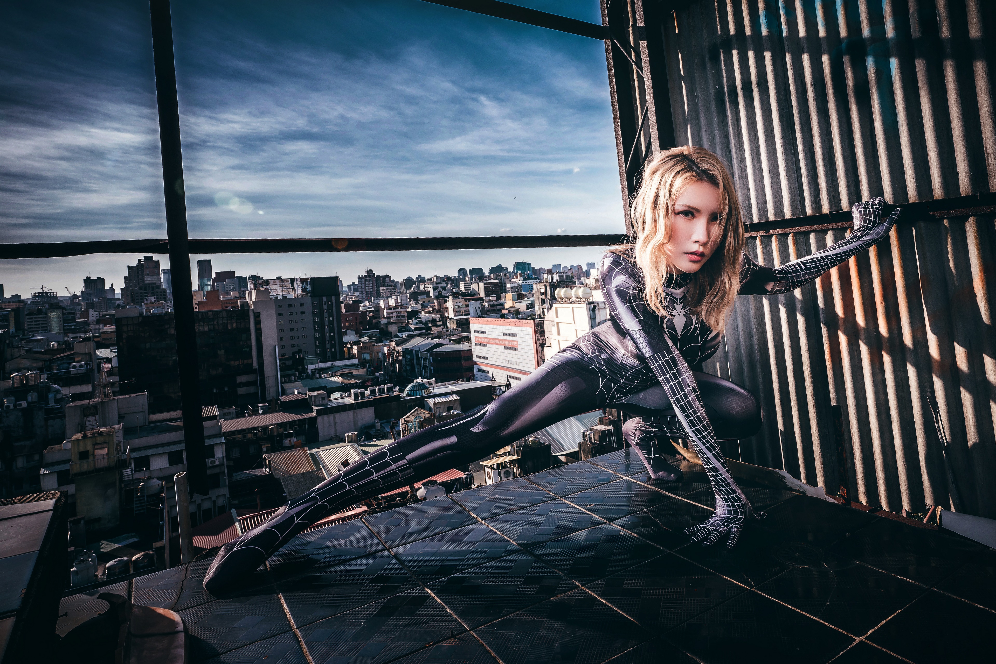 Spider-Woman Cosplayer Poses on Rooftop Overlooking City HD Wallpaper
