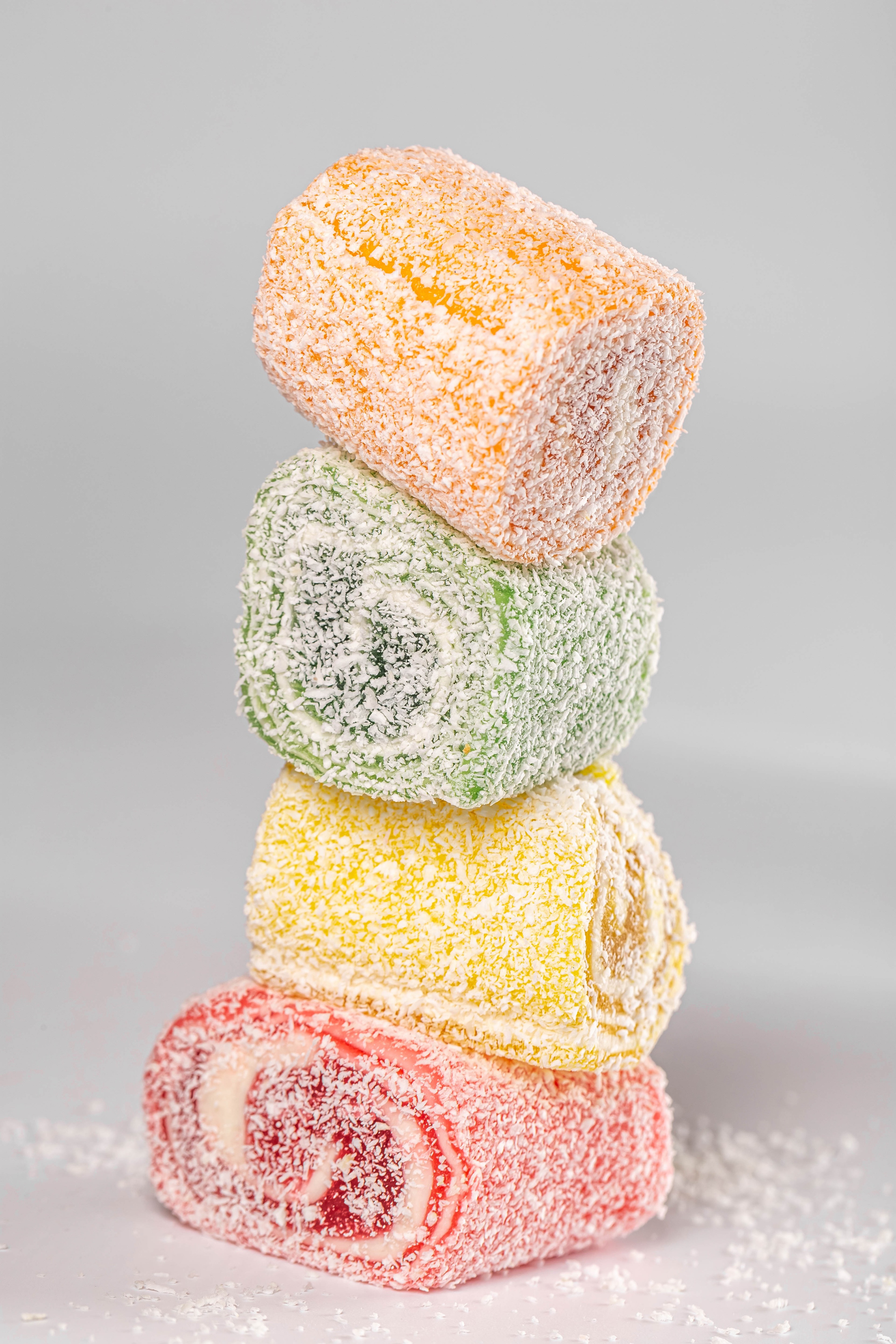 Stack of colorful Turkish Delight candies with coconut flakes HD Phone Wallpaper