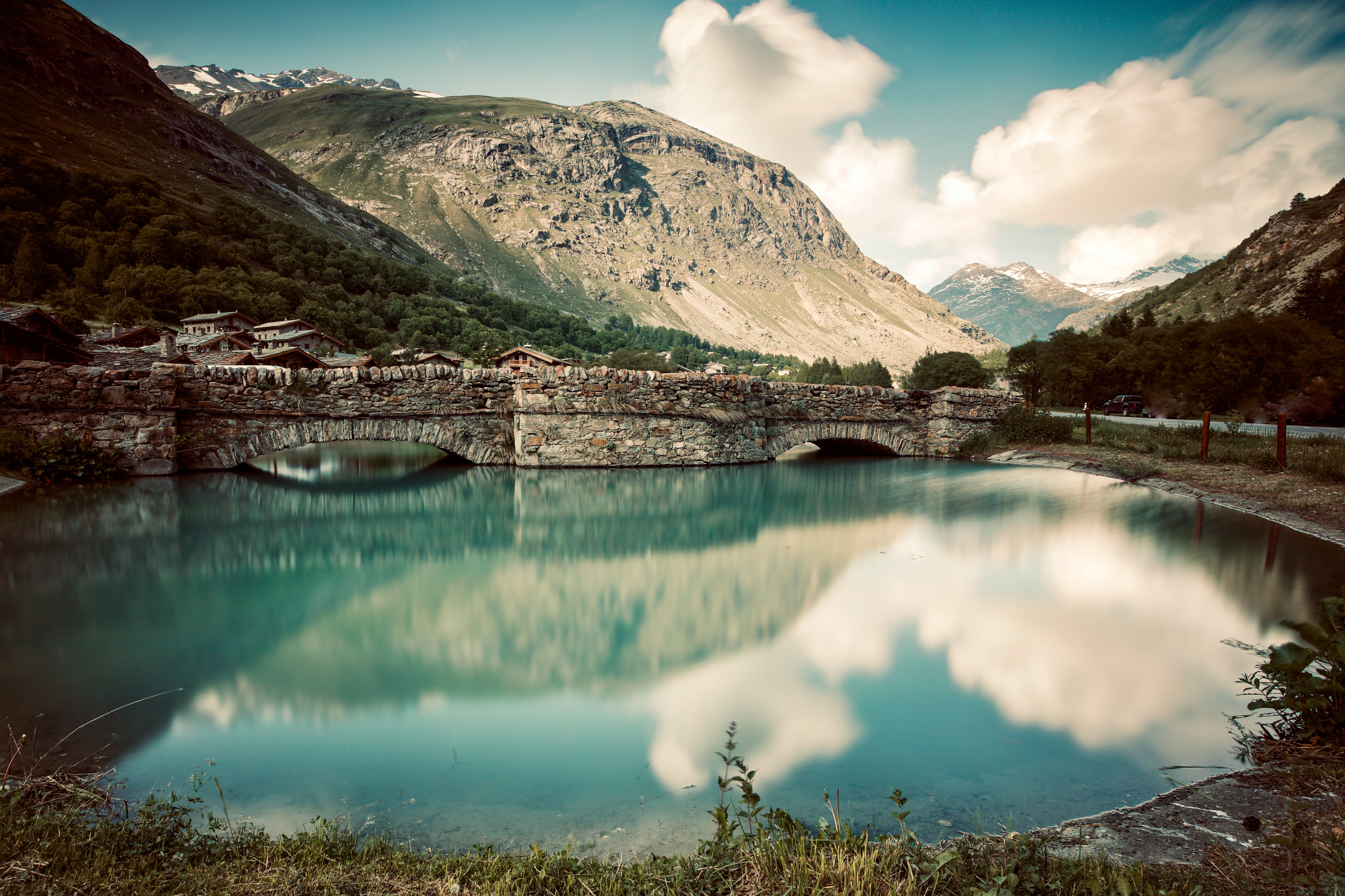 Stone bridge over a lake in Bonneval sur Arc, France HD Wallpaper