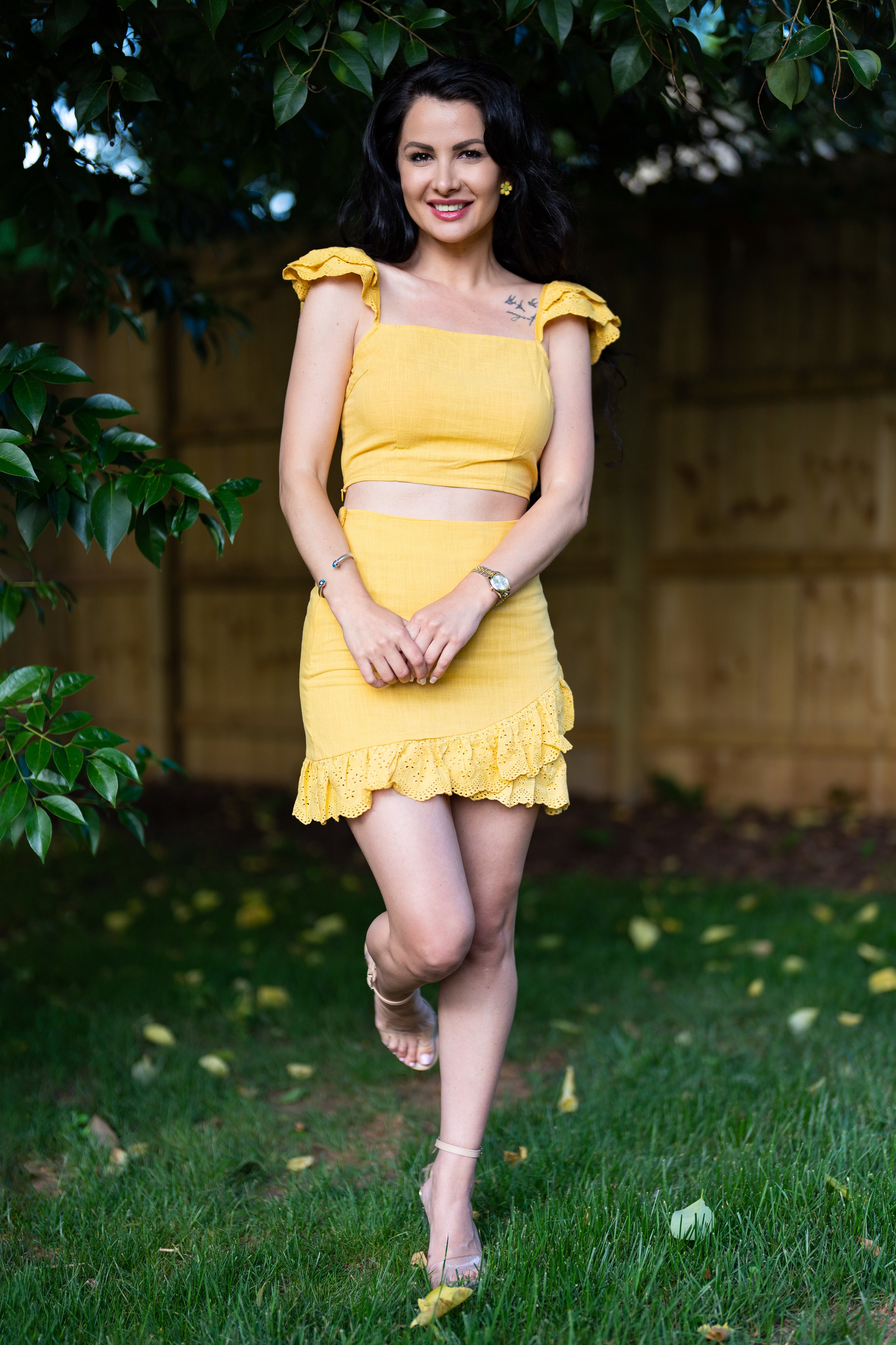 Brunette girl in yellow outfit posing outdoors HD Phone Wallpaper