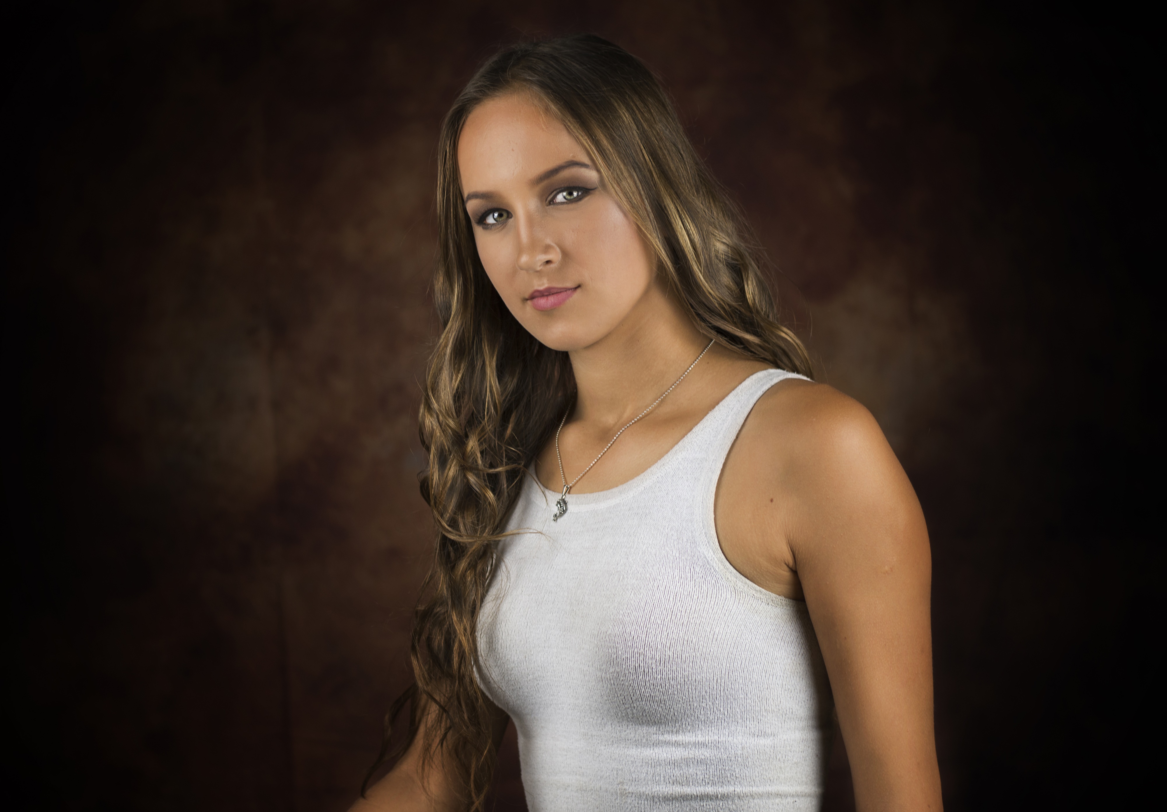 Woman with brown hair wearing a white singlet and necklace HD Wallpaper