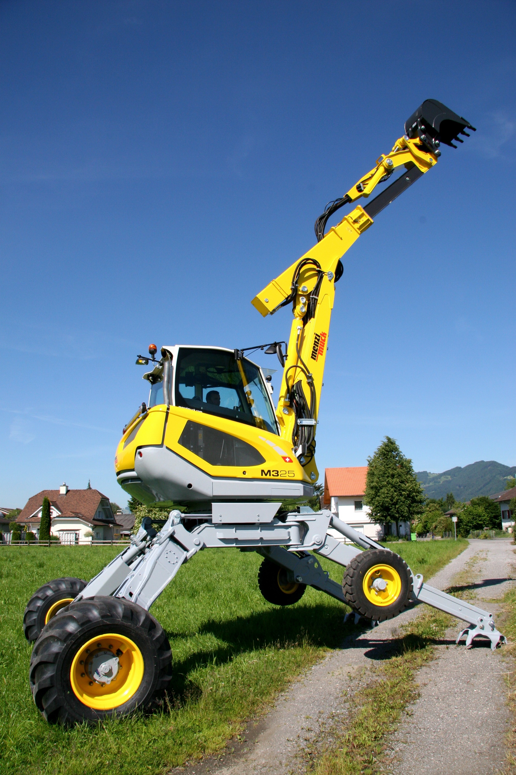 Menzi Muck M325 excavator on a sunny day HD Phone Wallpaper