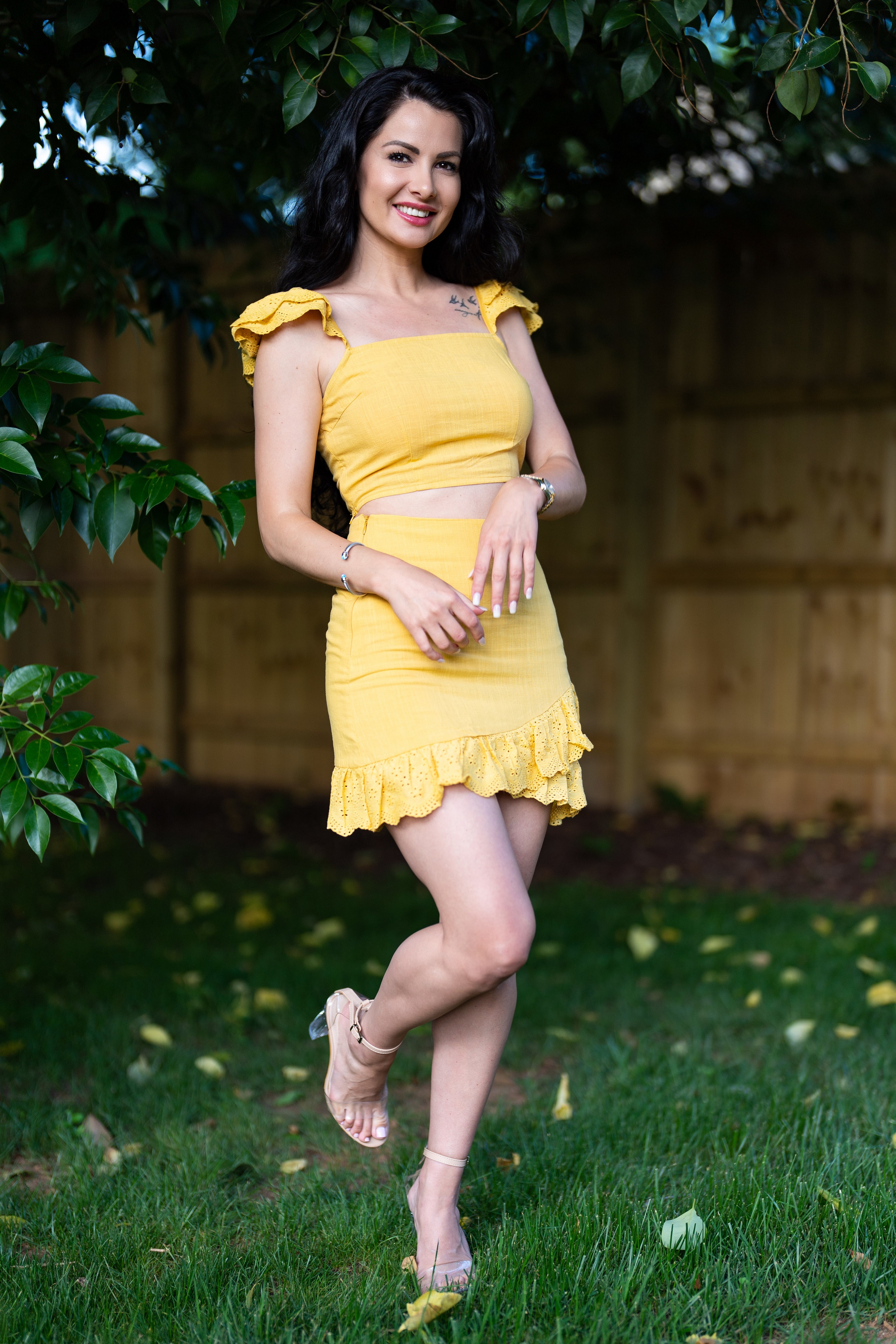 Brunette girl in yellow outfit posing outdoors HD Phone Wallpaper