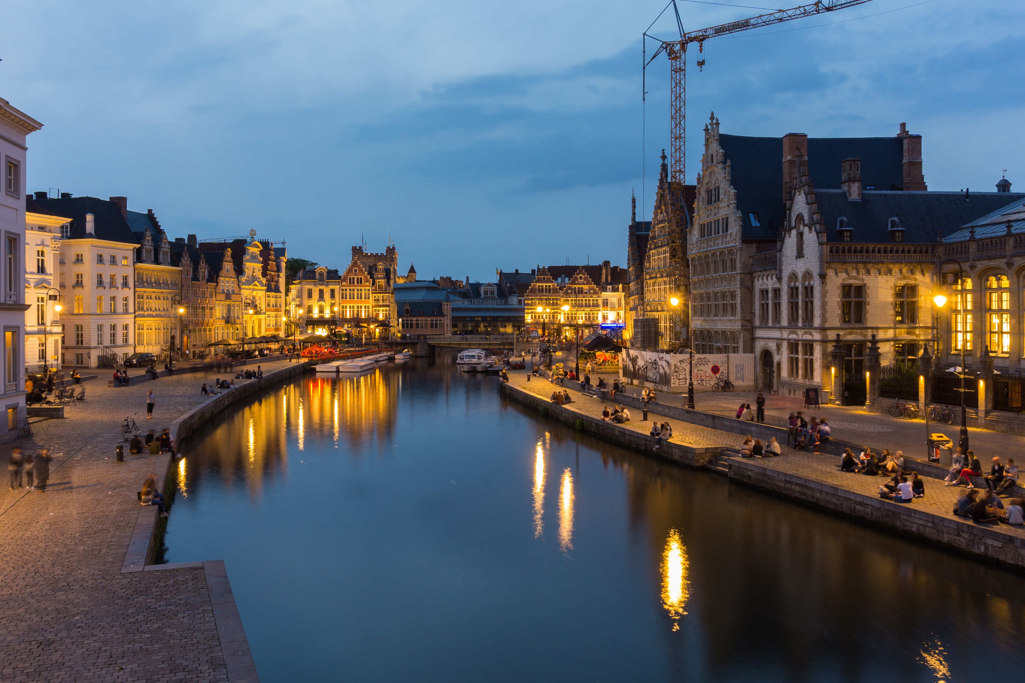 Ghent, Belgium canal at dusk with illuminated buildings and people HD Wallpaper