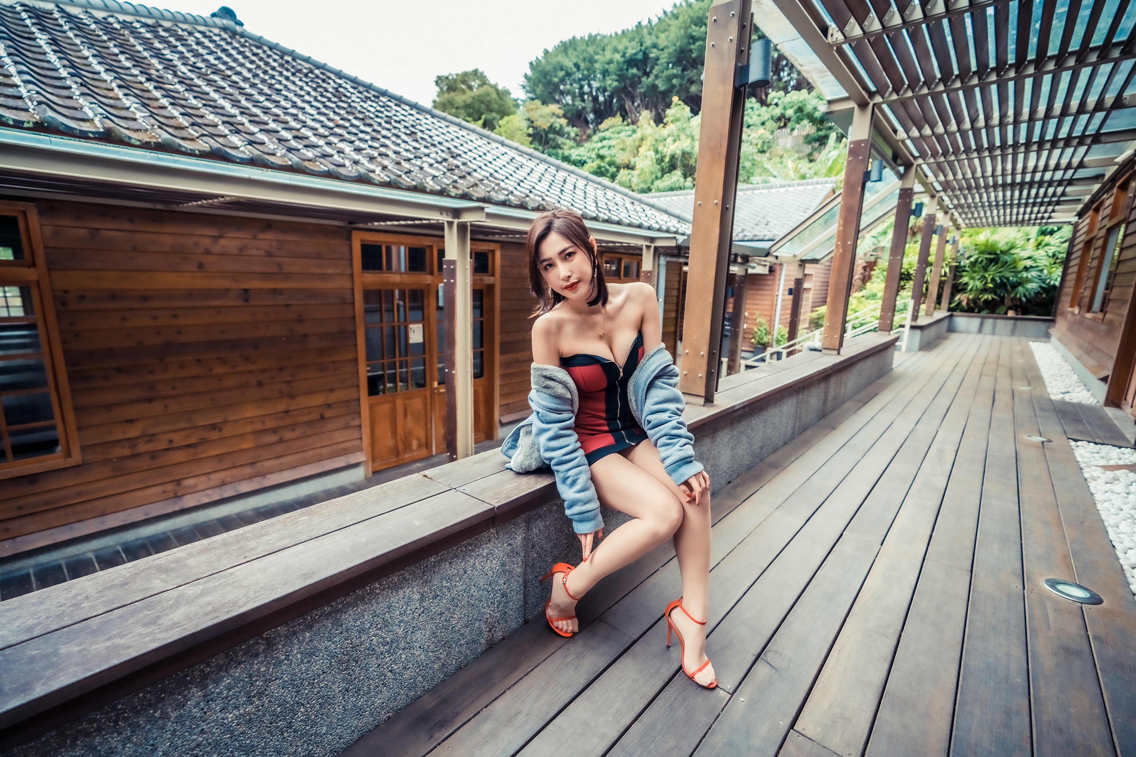 Asian woman in dress sitting on wooden bench HD Wallpaper
