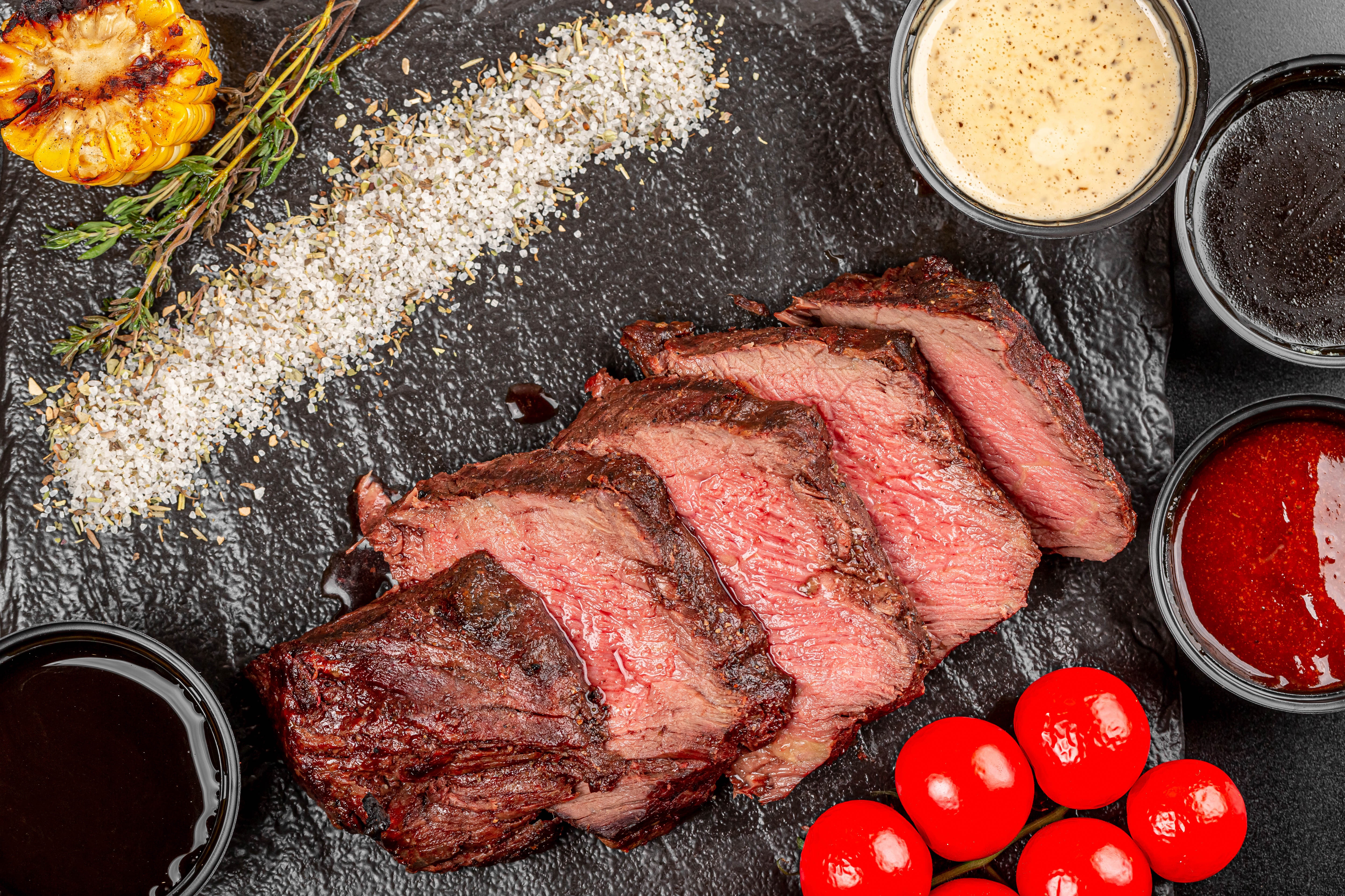 Sliced steak with sauces and grilled corn HD Wallpaper