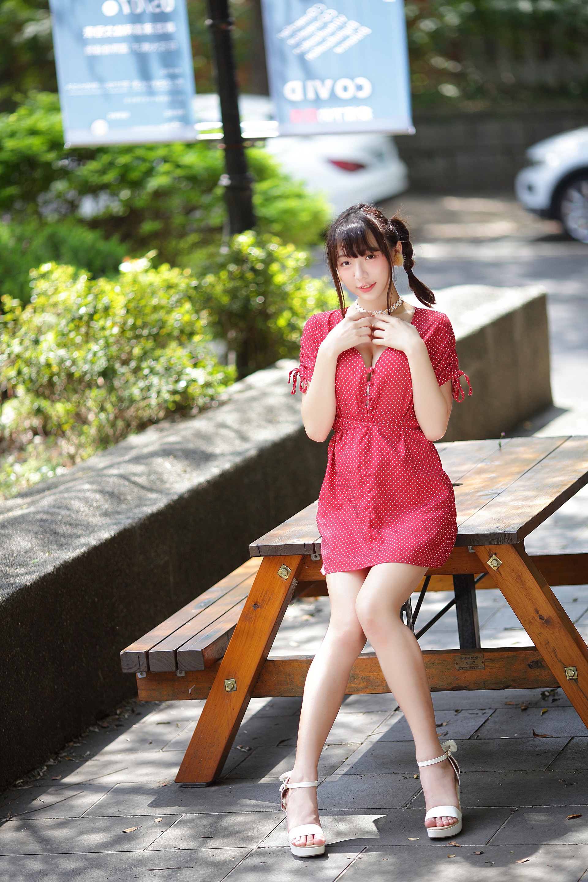 Asian woman in red polka dot dress sitting on a bench HD Phone Wallpaper