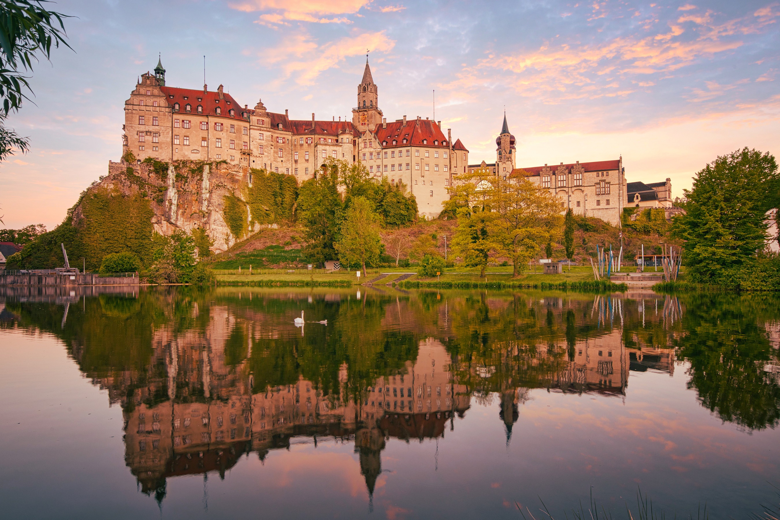 Sigmaringen Castle reflected in a lake at sunset HD Wallpaper