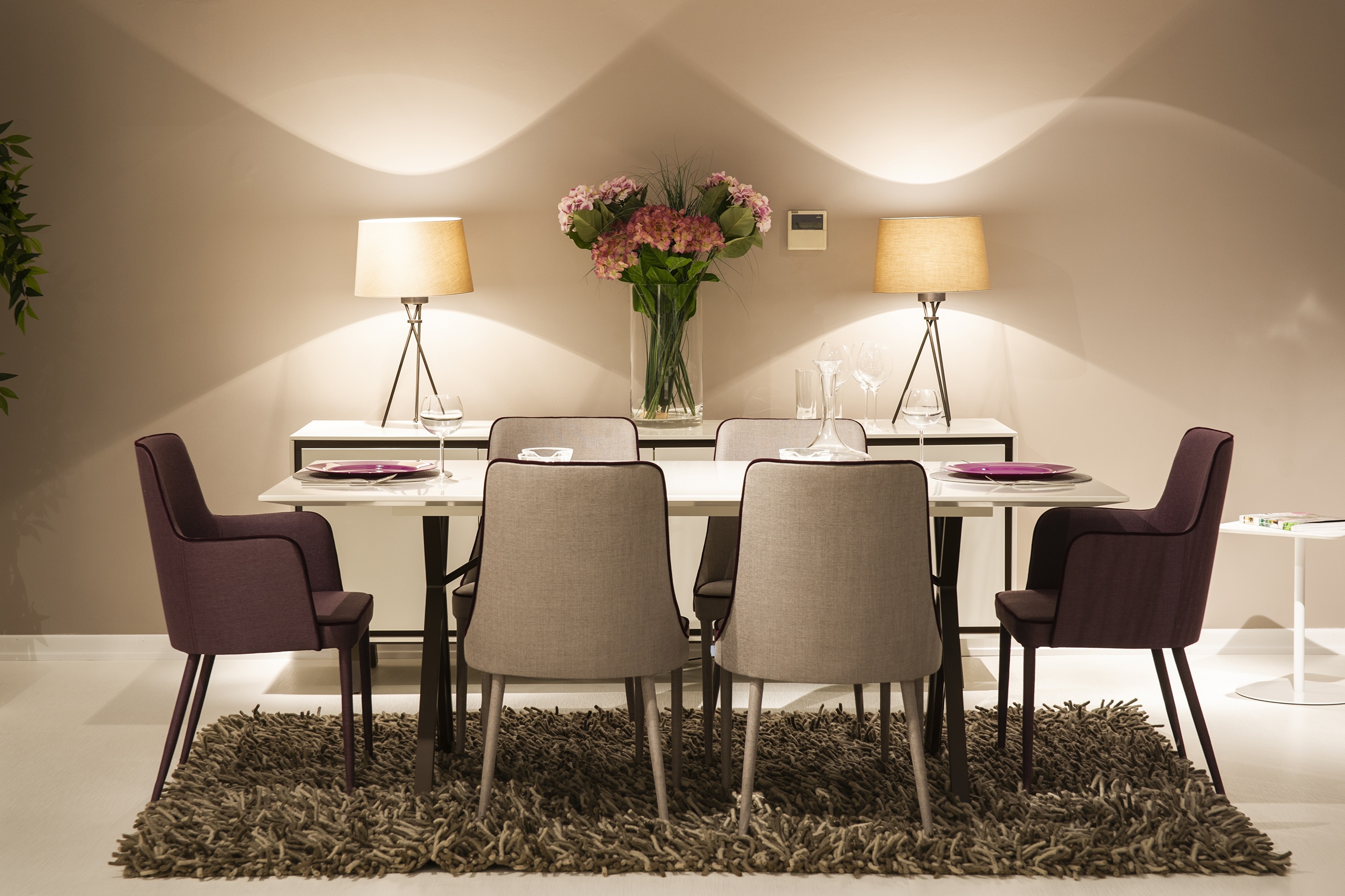 Dining table with chairs, lamps, and flowers HD Wallpaper