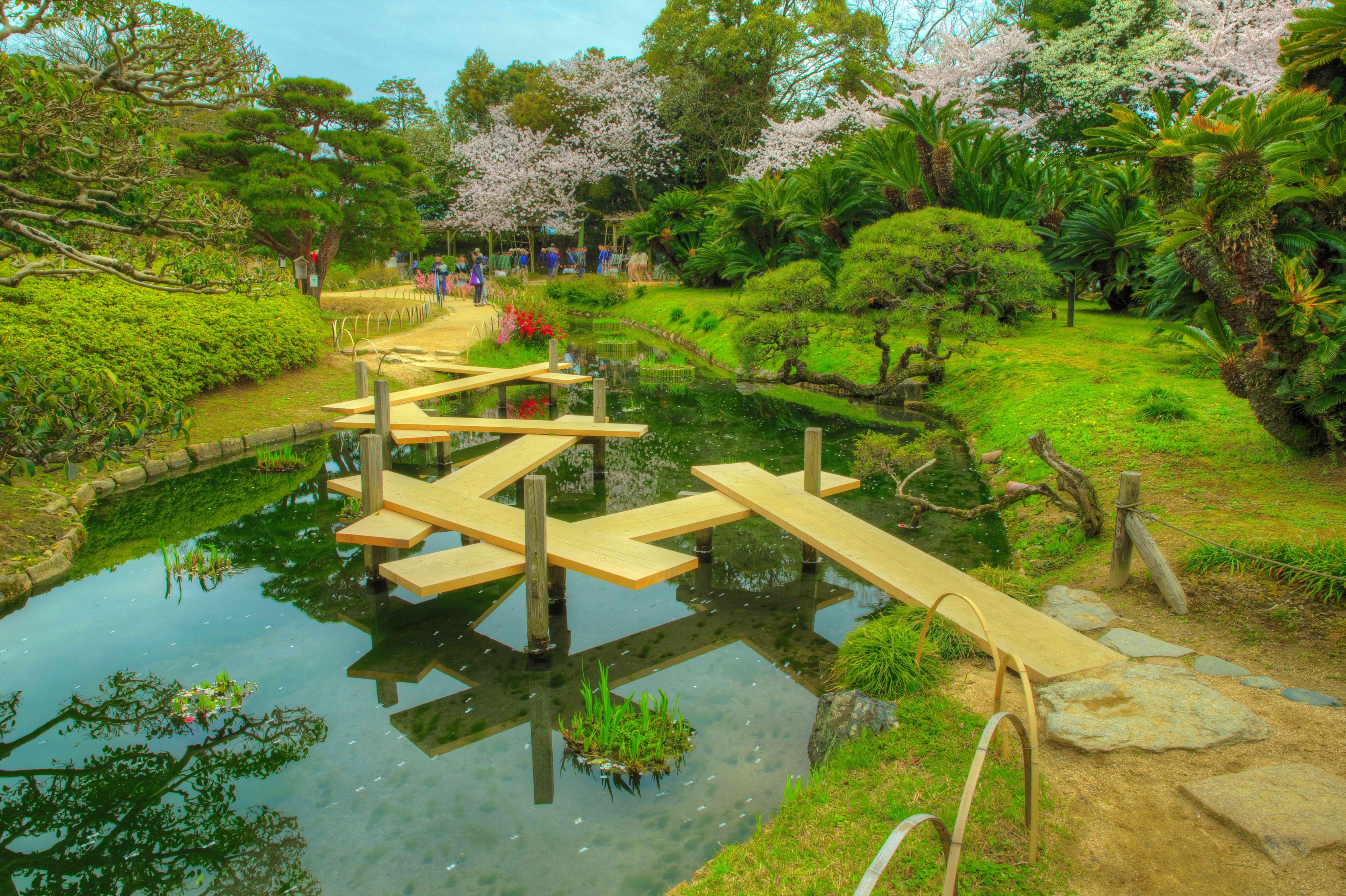Wooden bridges over a pond in Okayama Korakuen Garden, Japan HD Wallpaper