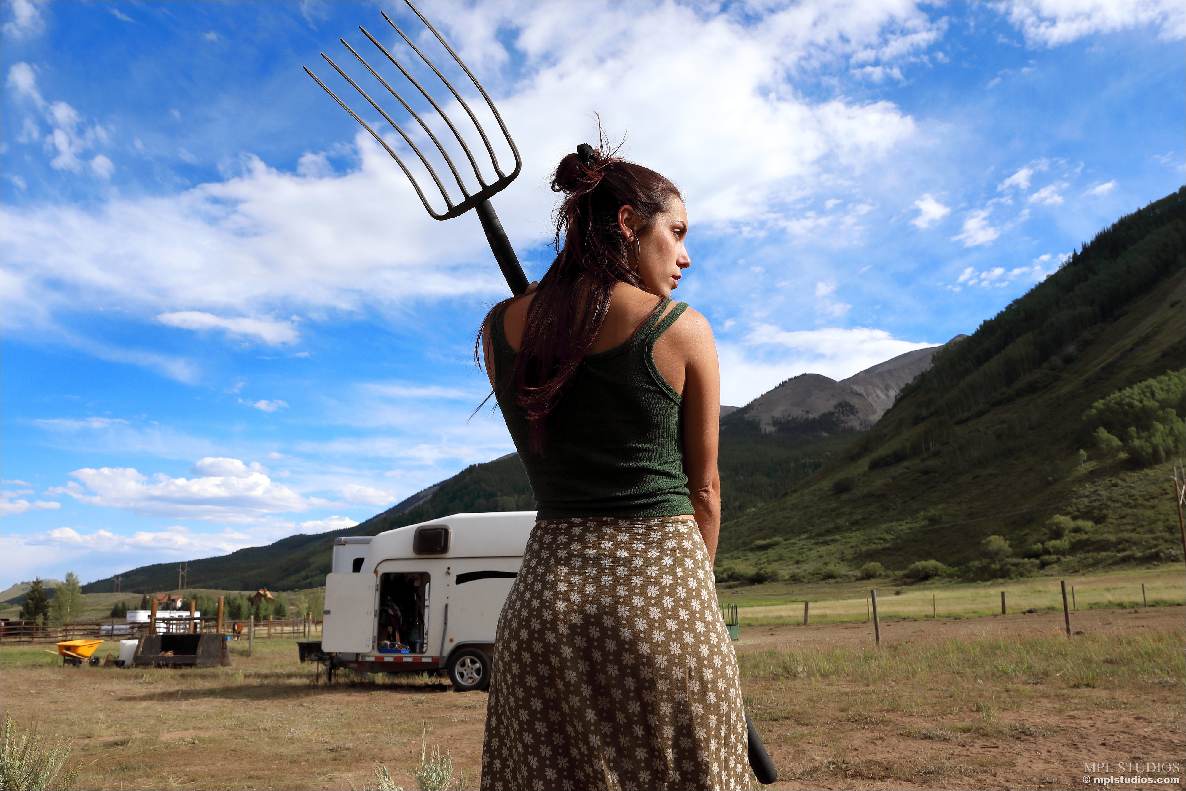 Elena Generi with Pitchfork in Rural Landscape HD Wallpaper