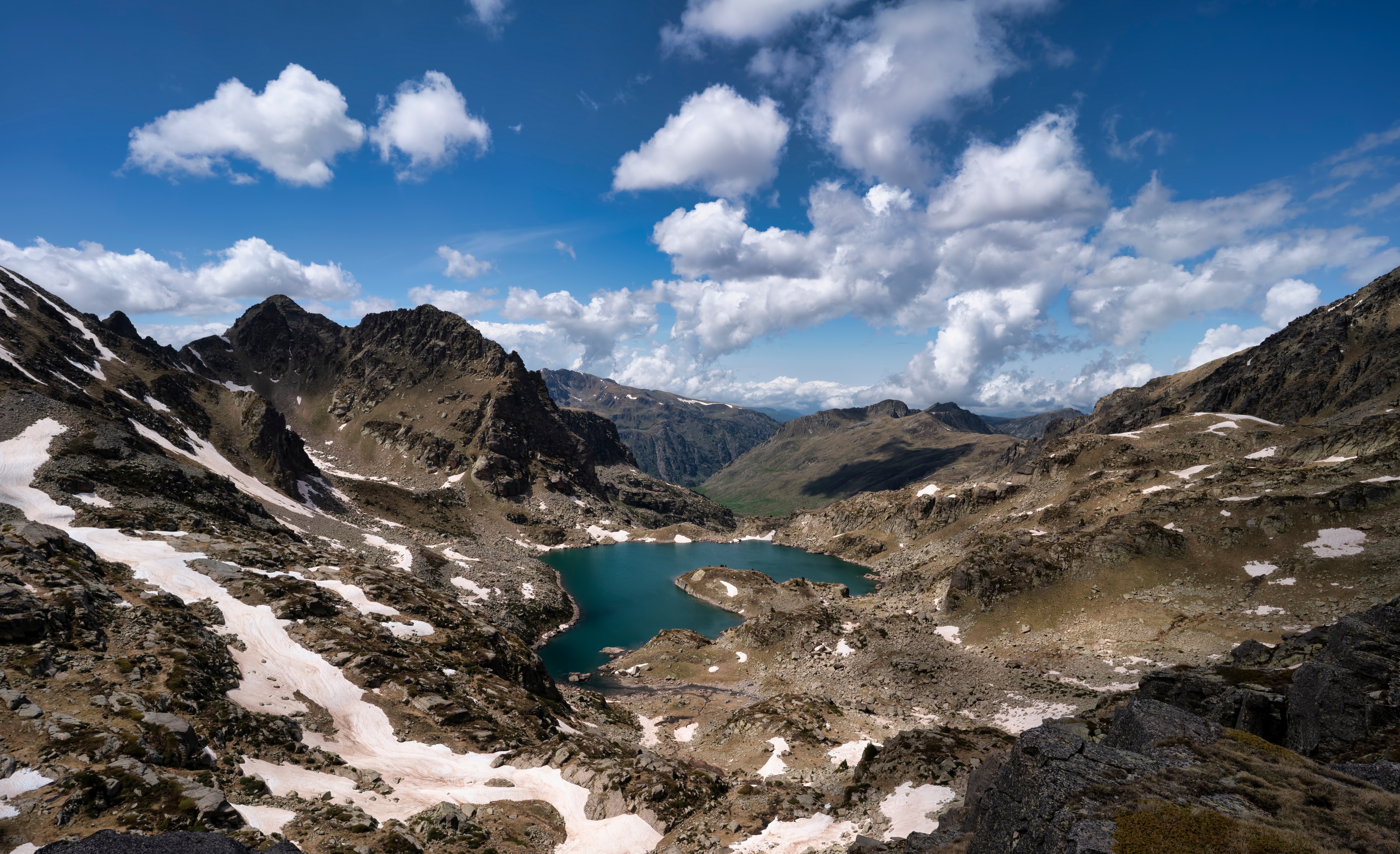 Mountain lake with snow patches and clouds HD Wallpaper