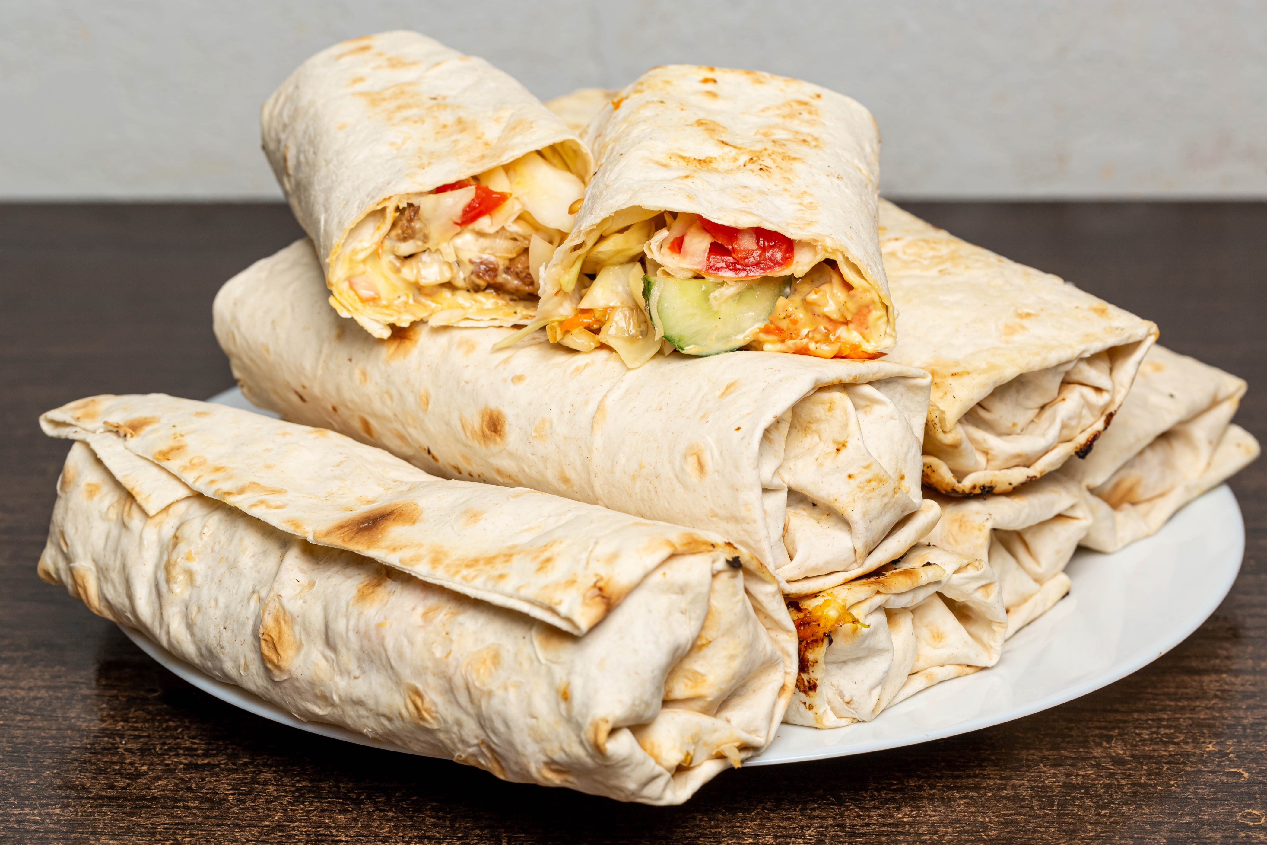 Shawarma wraps with vegetables on a plate HD Wallpaper
