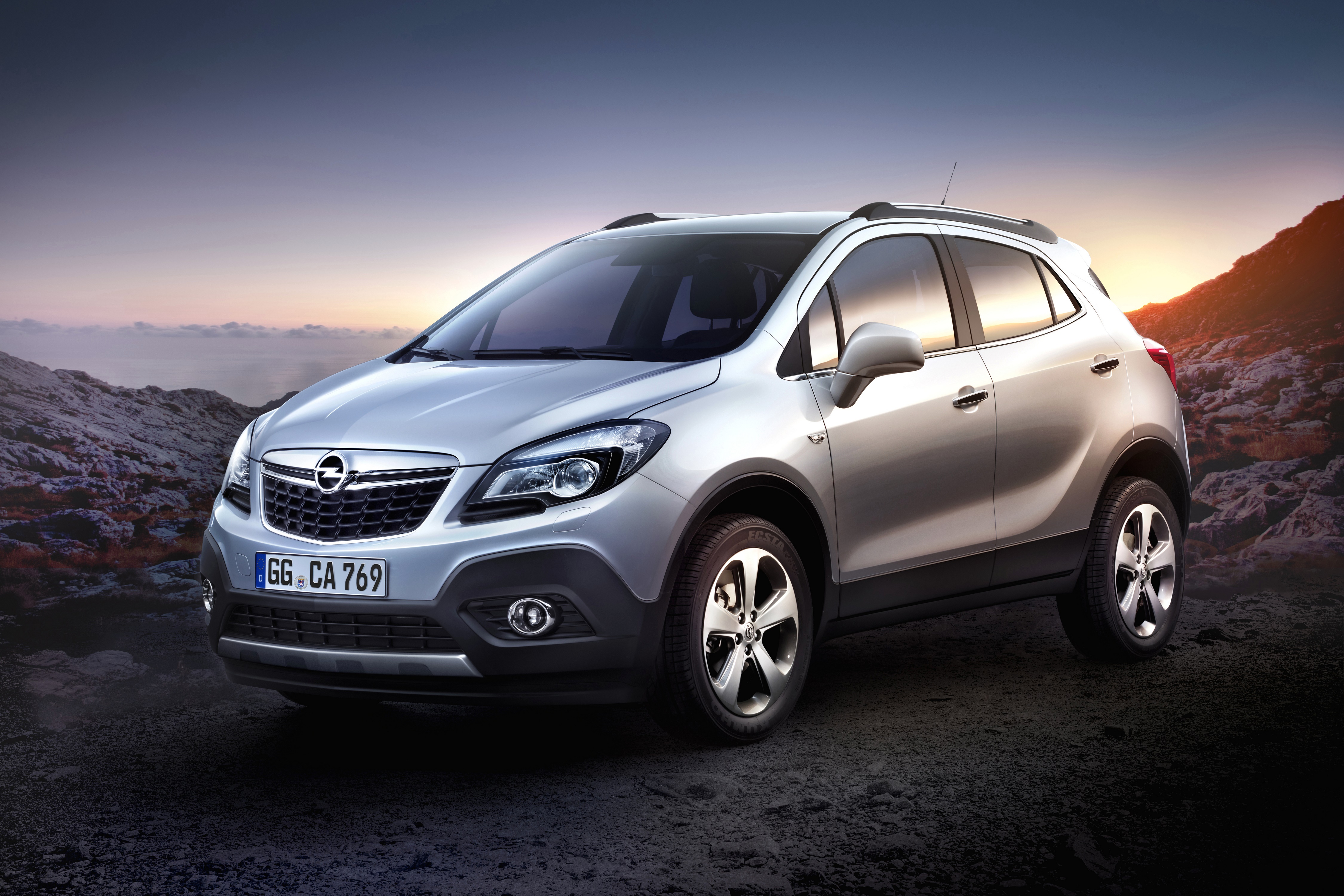 Silver Opel Mokka Crossover parked on rocky terrain HD Wallpaper