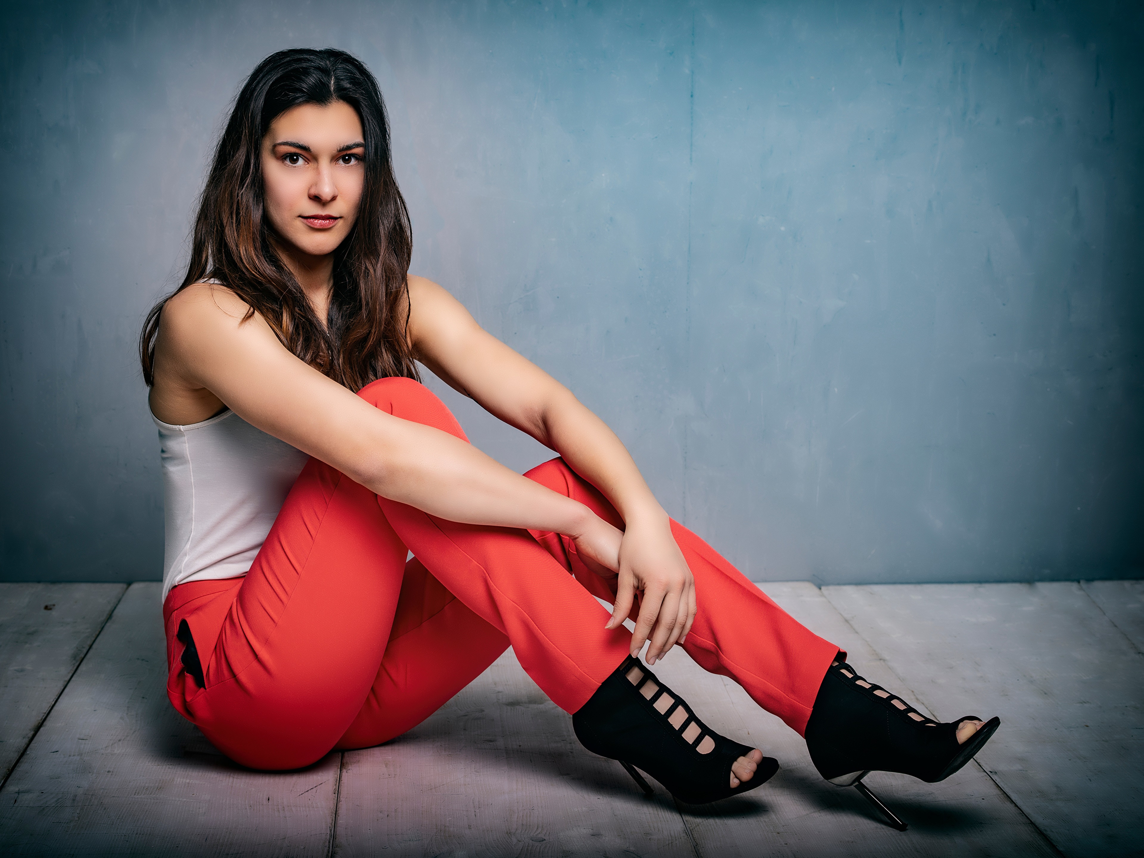 Angelina sitting in red trousers and white singlet HD Wallpaper