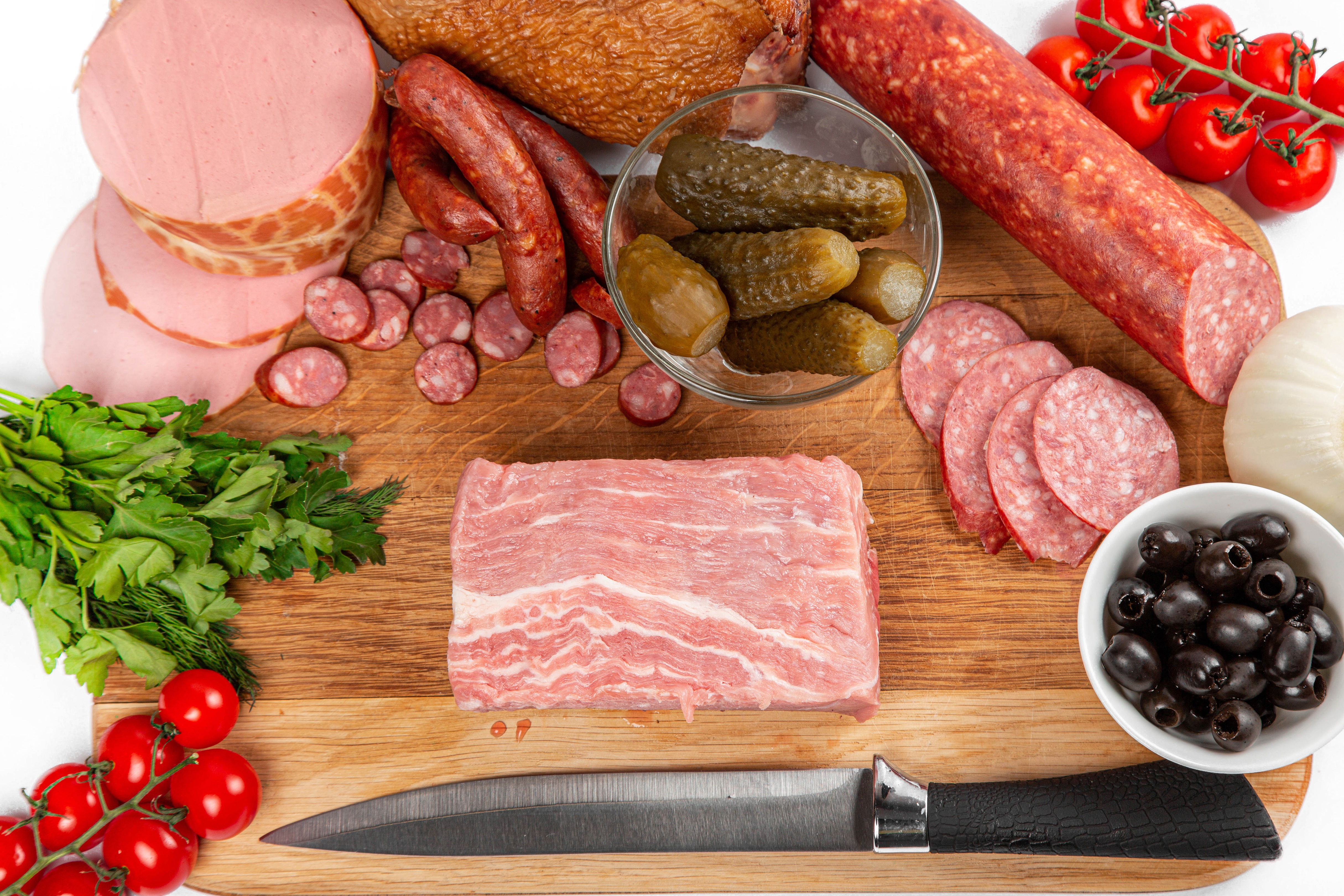 Sausage, Olives, Tomatoes, Cucumbers, and Raw Meat on Cutting Board with Knife HD Wallpaper