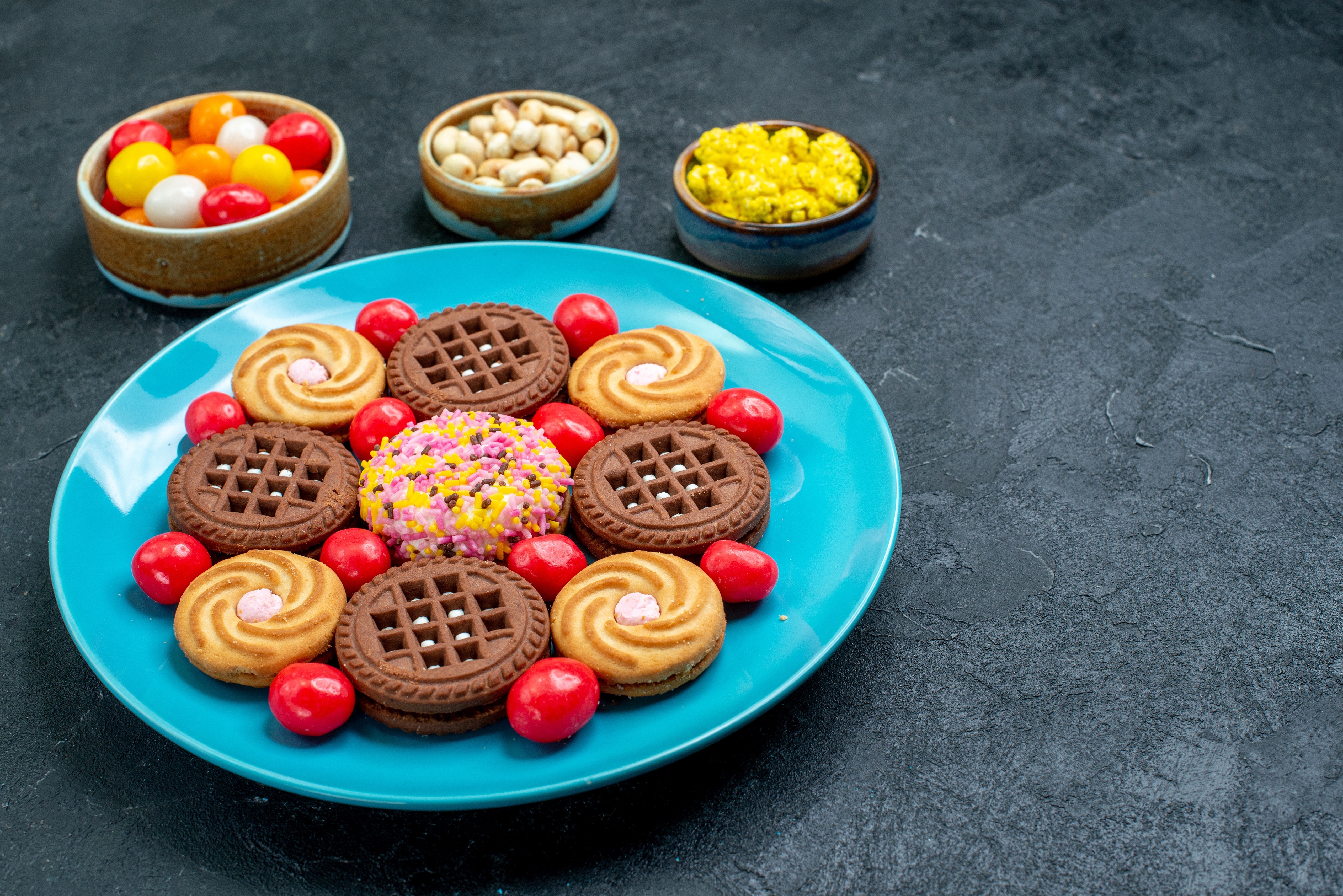 Cookies and candies on a blue plate HD Wallpaper