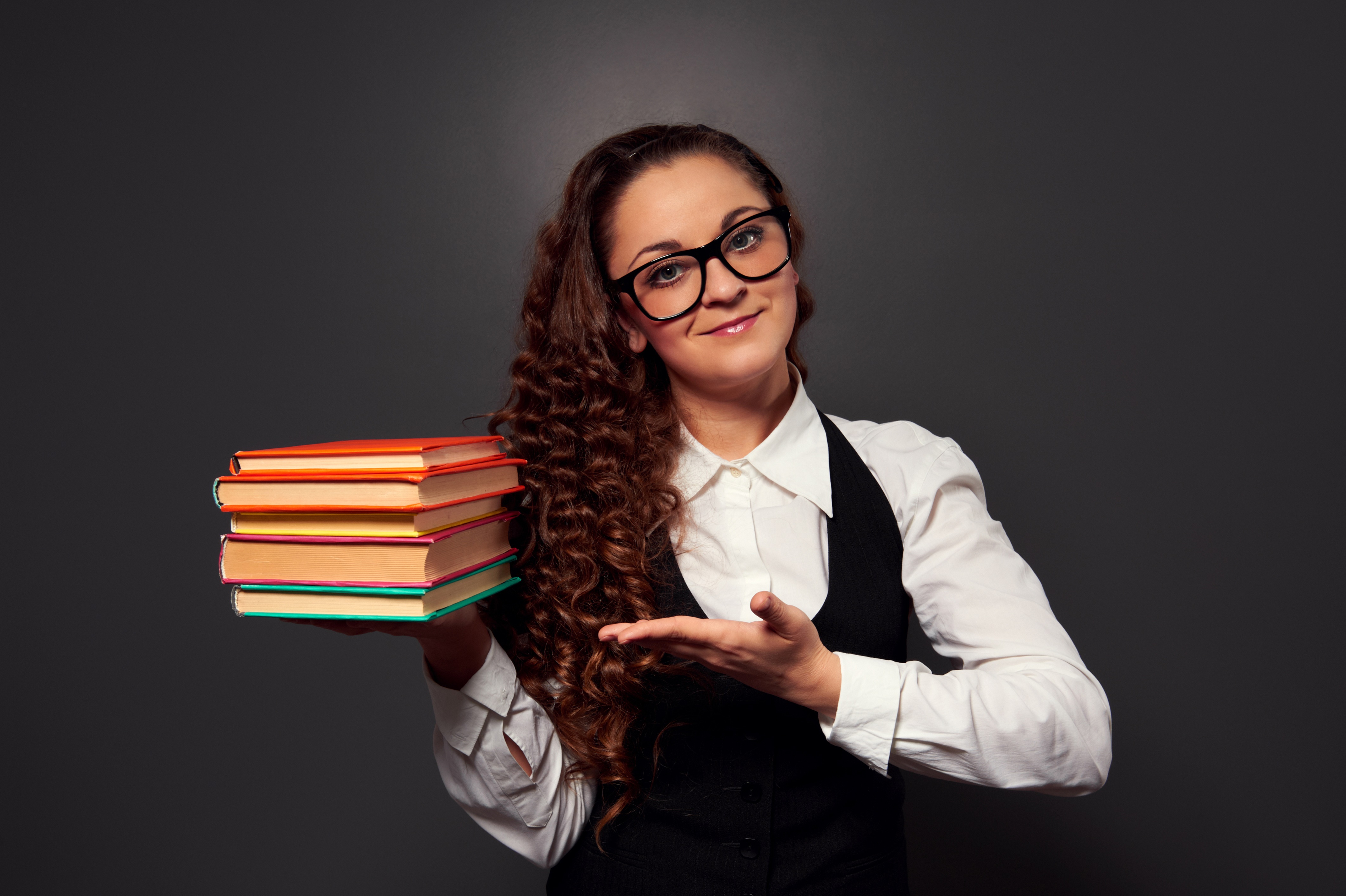 Woman with glasses holding books HD Wallpaper