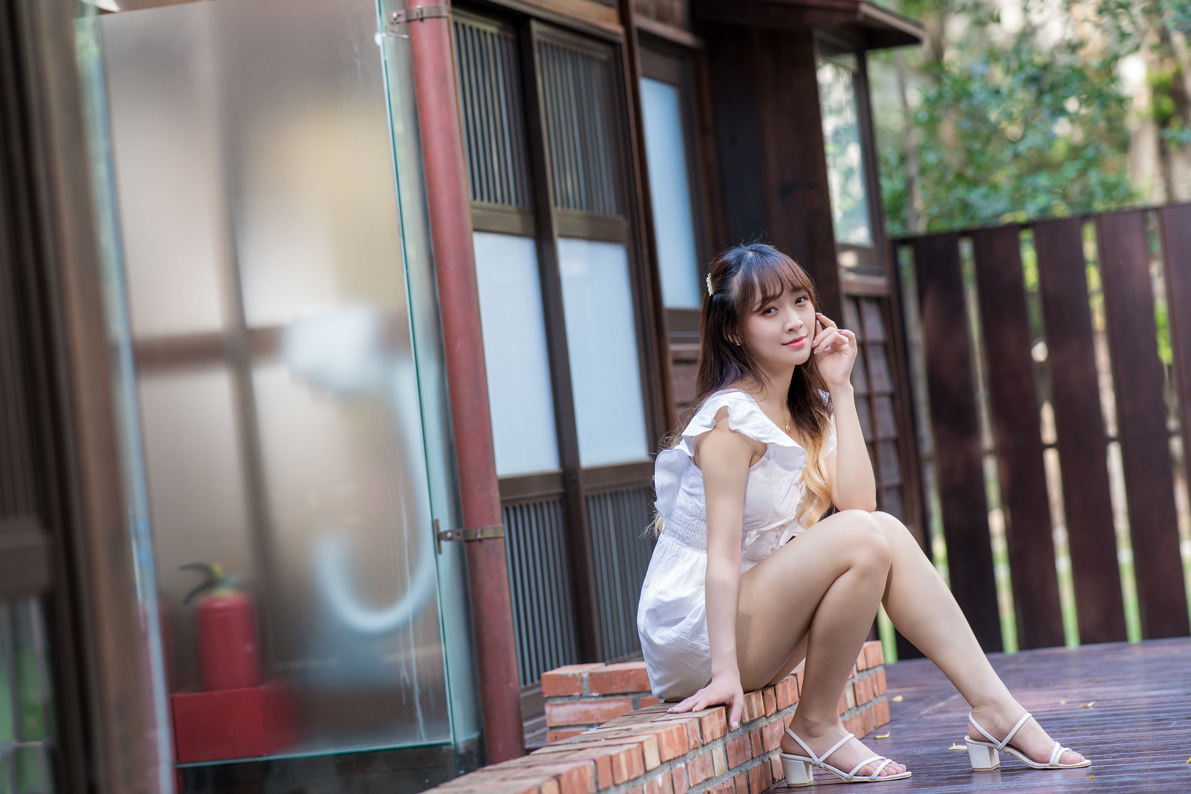 Asian woman in white dress sitting outdoors HD Wallpaper