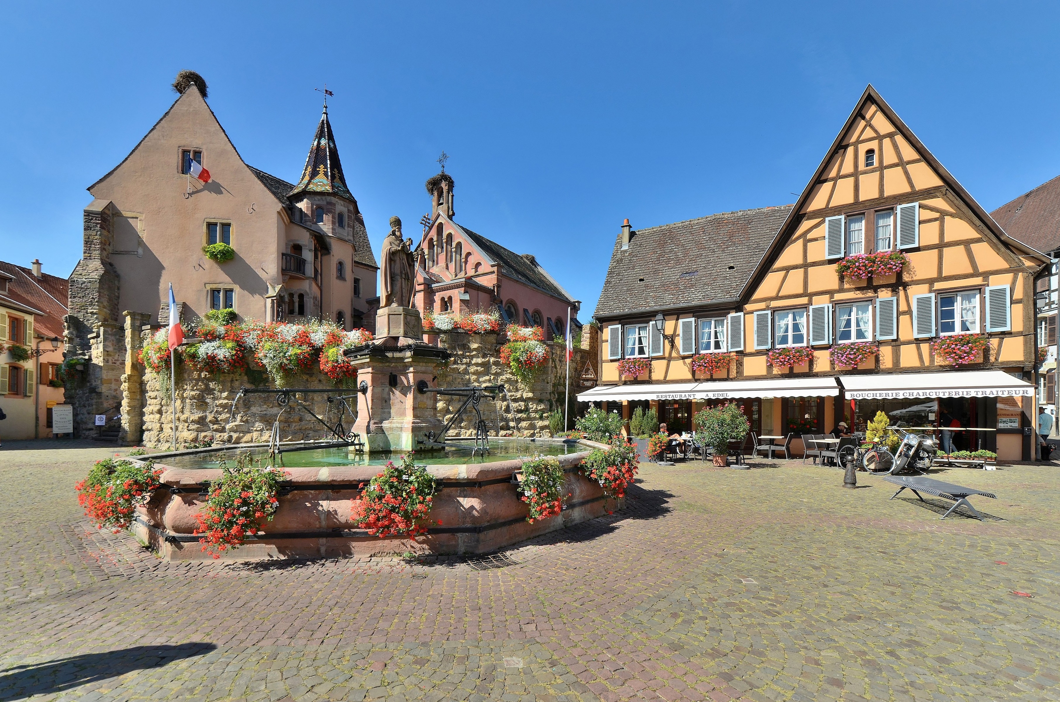 Fountain and half-timbered houses in Eguisheim, France HD Wallpaper