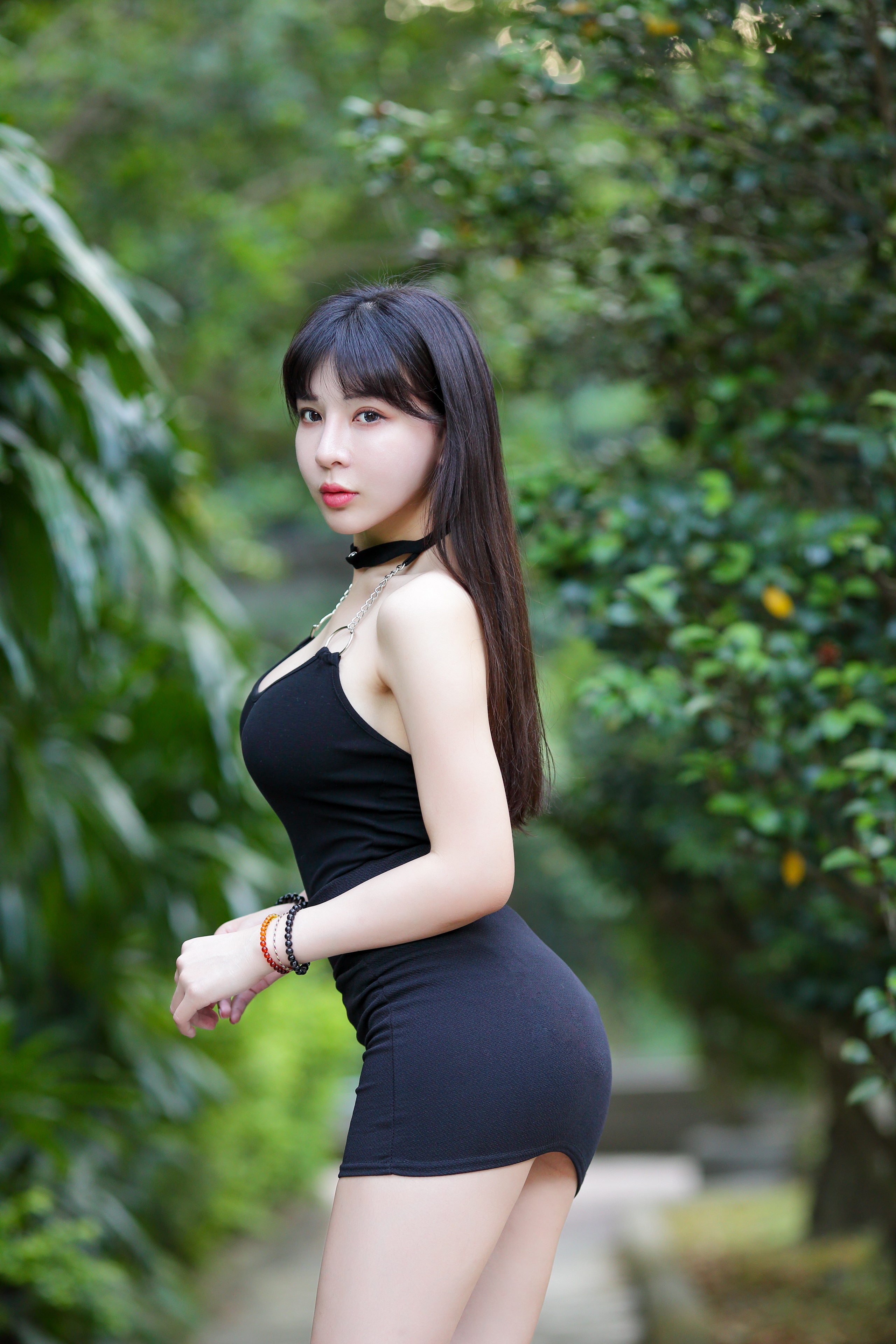 Asian woman in black dress posing outdoors HD Phone Wallpaper