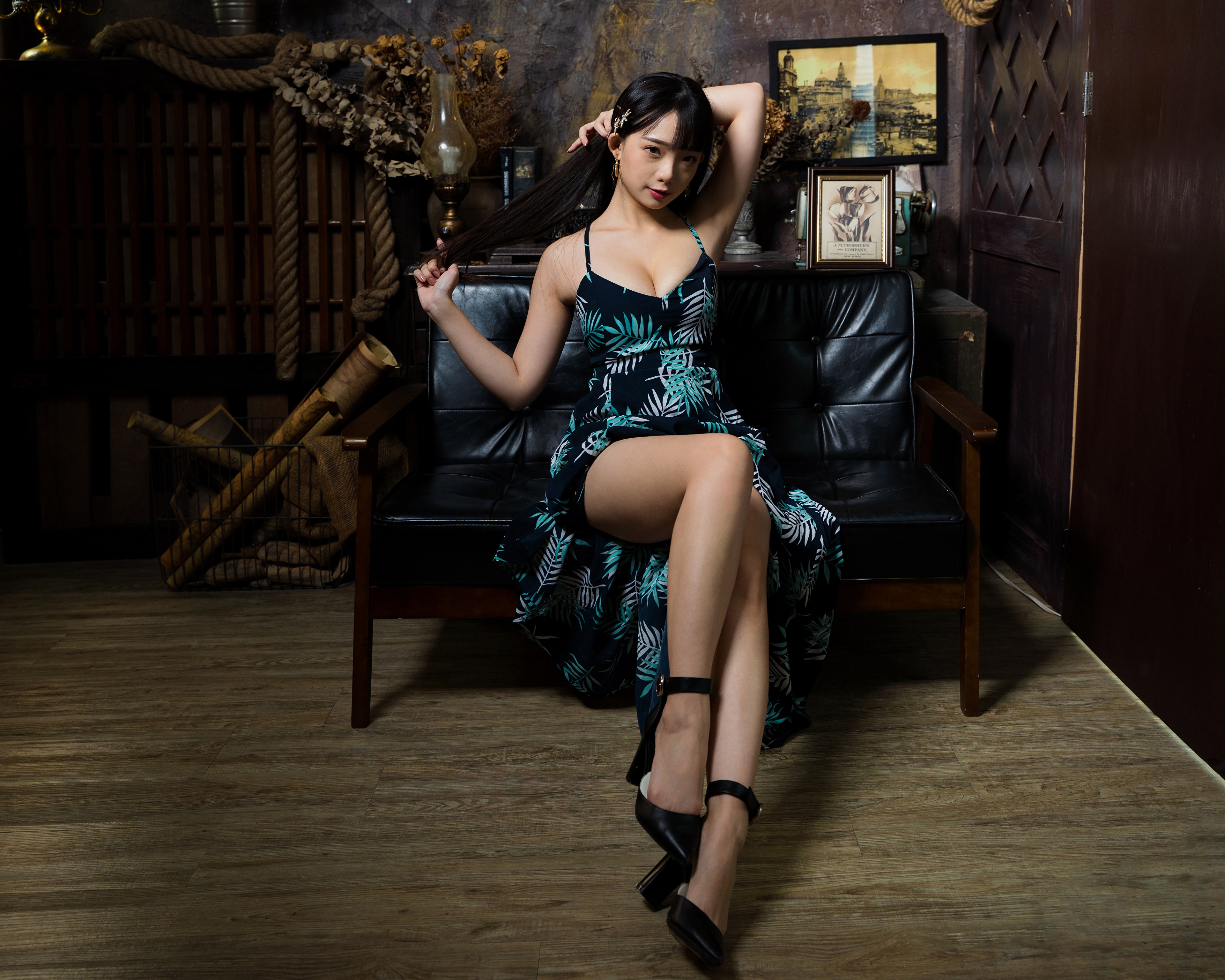 Brunette girl in a dress sitting on a sofa HD Wallpaper