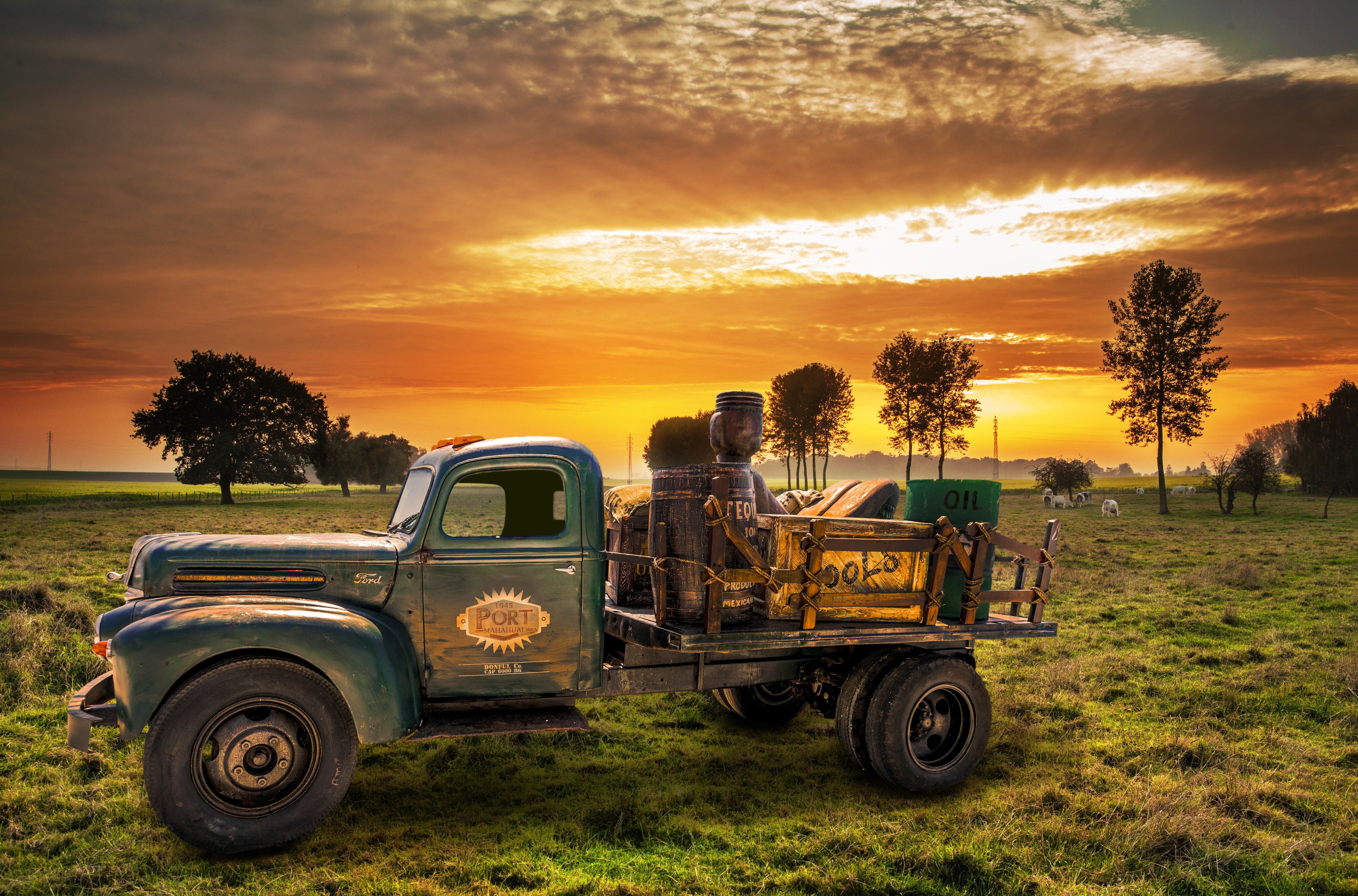 Retro Ford truck loaded with barrels and oil at sunset HD Wallpaper