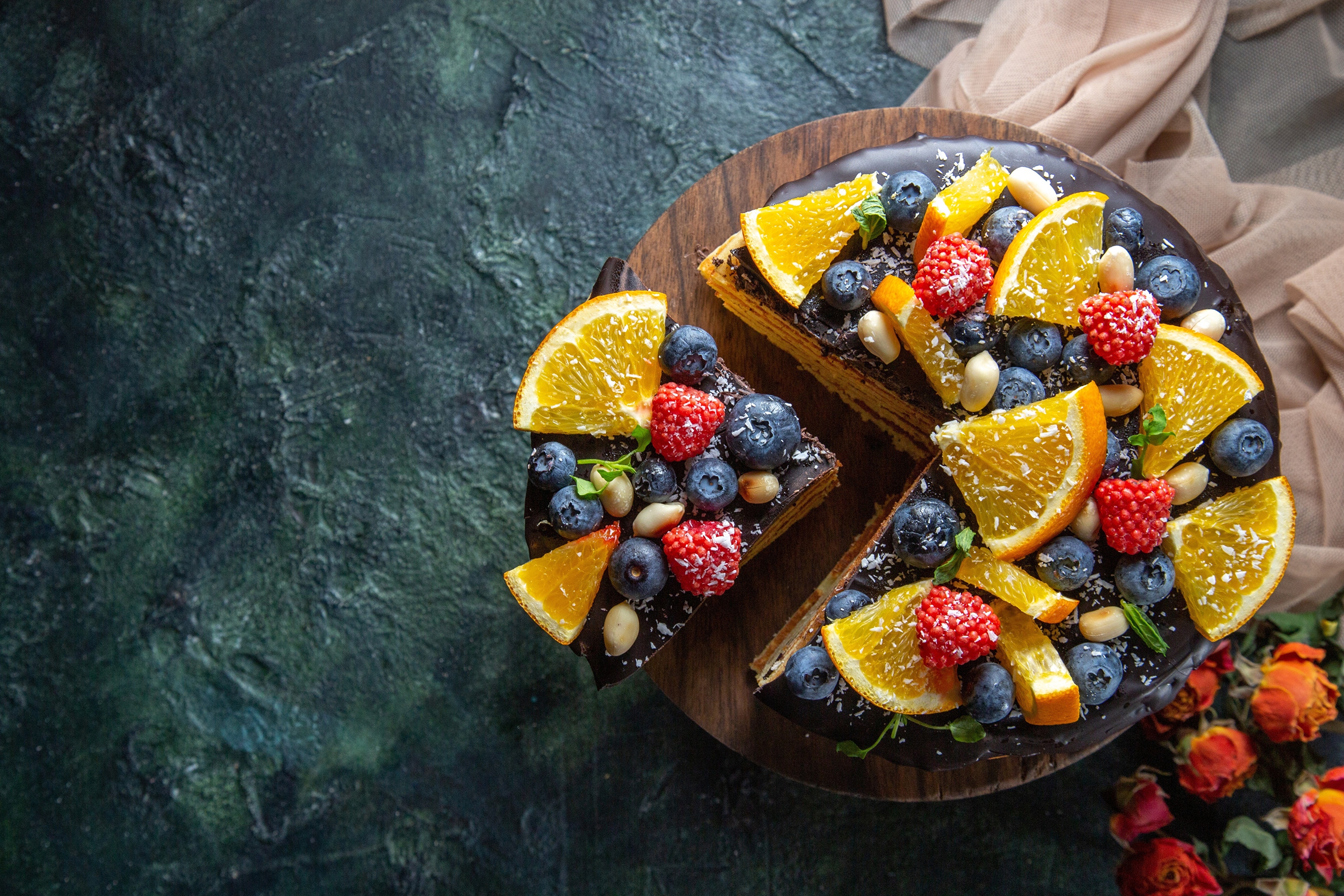 Chocolate cake with blueberries, raspberries, and orange slices HD Wallpaper