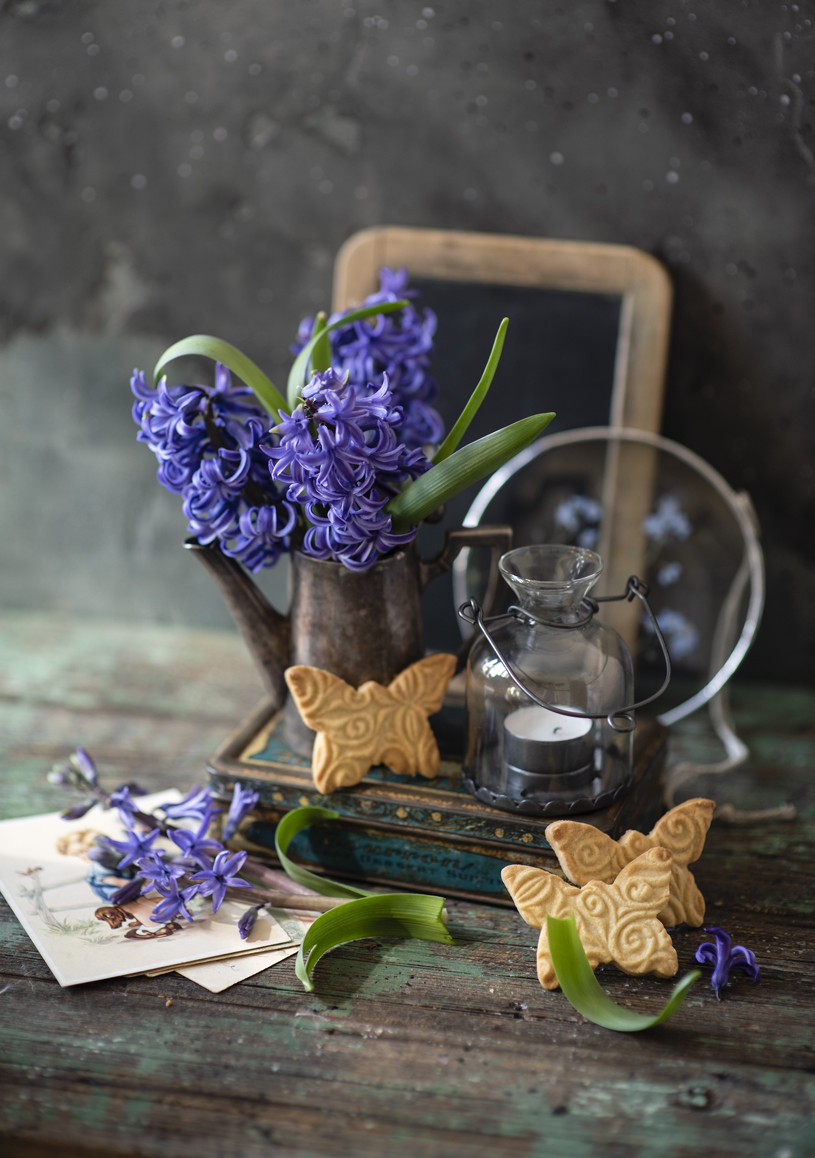 Hyacinths and butterfly cookies on a wooden table HD Phone Wallpaper