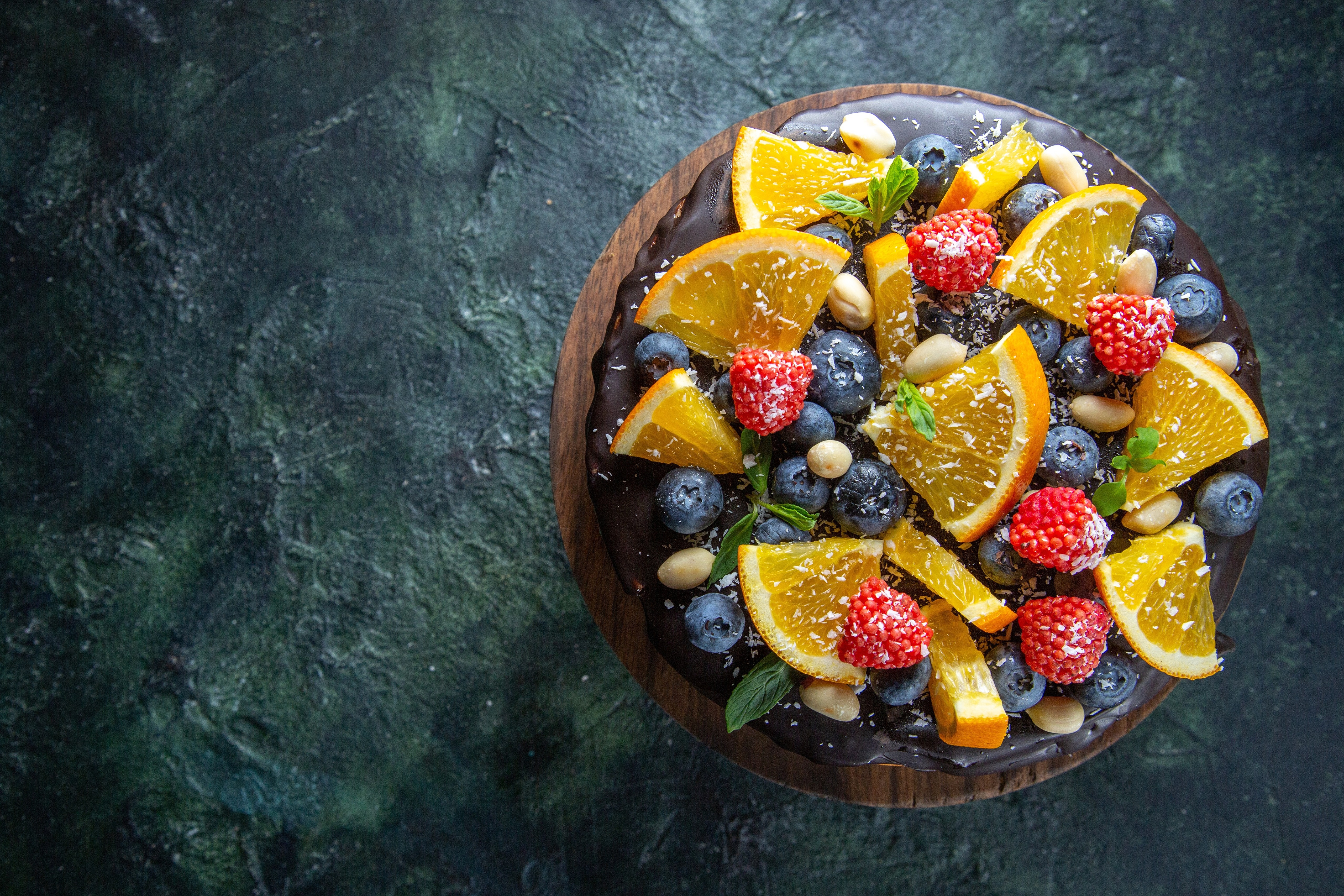 Chocolate cake with orange, raspberries, blueberries, and nuts HD Wallpaper
