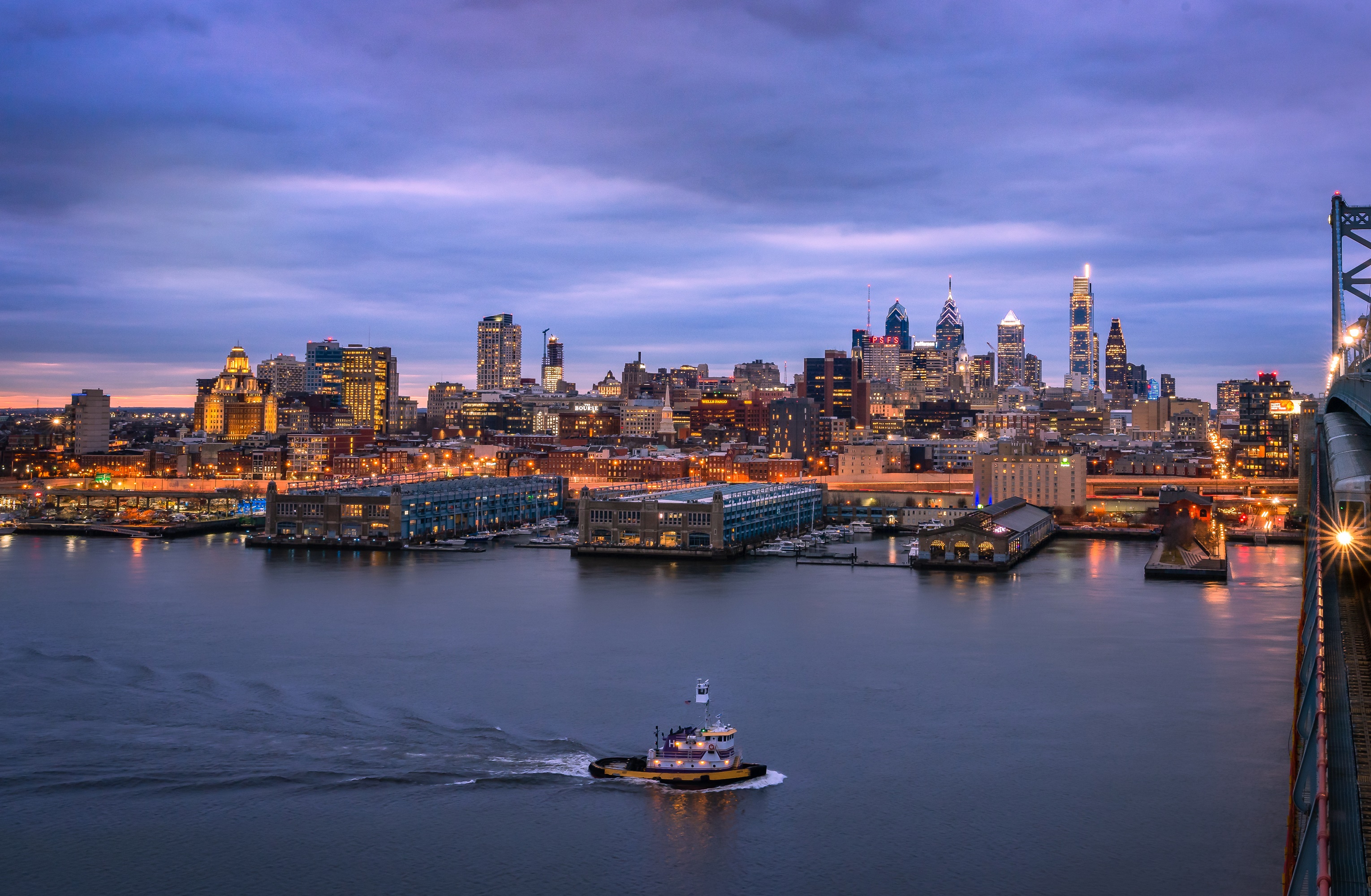 Philadelphia skyline at dusk with a tugboat on the river HD Wallpaper