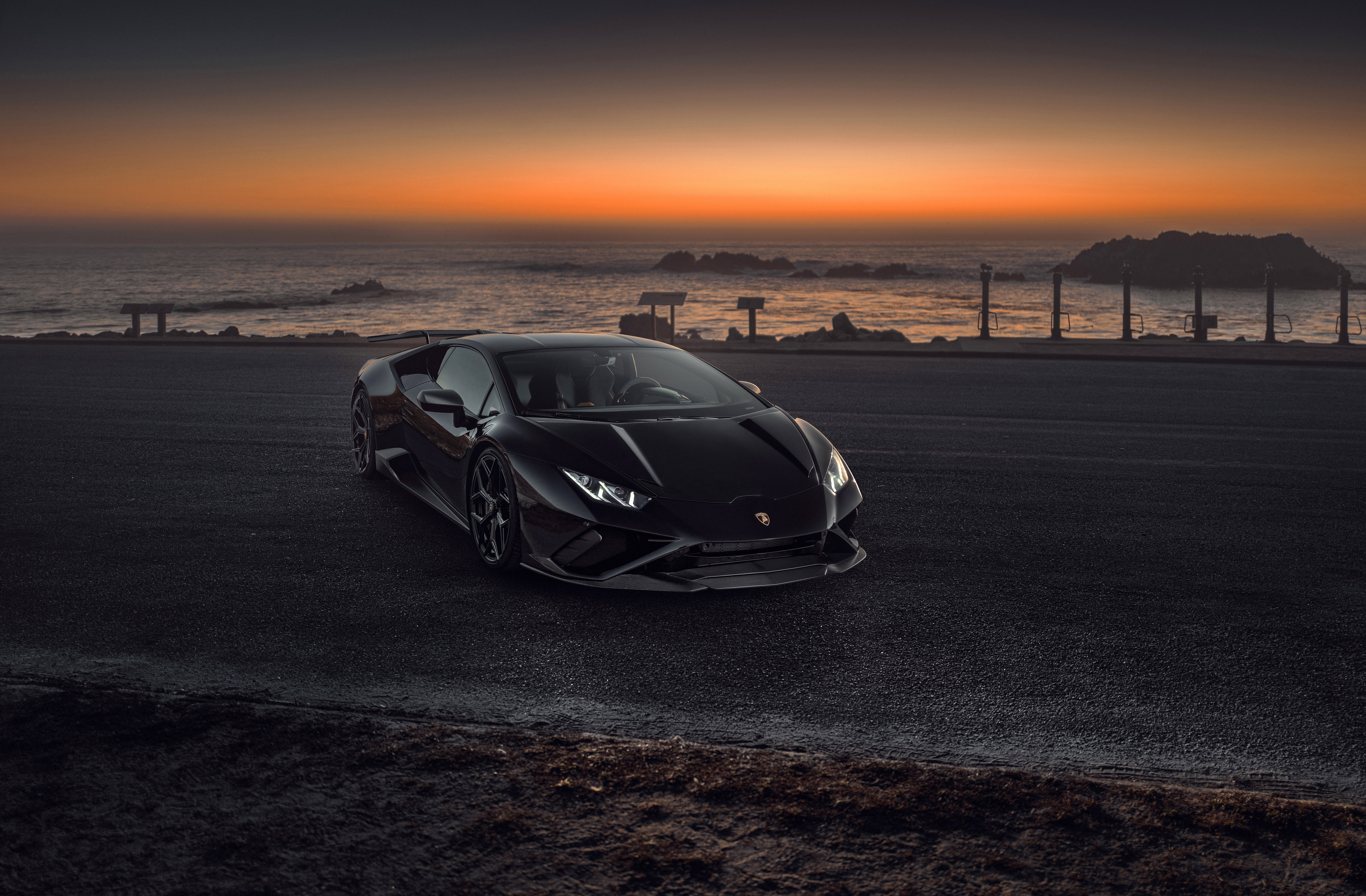 Black Lamborghini Coupe on Road by Ocean at Sunset HD Wallpaper