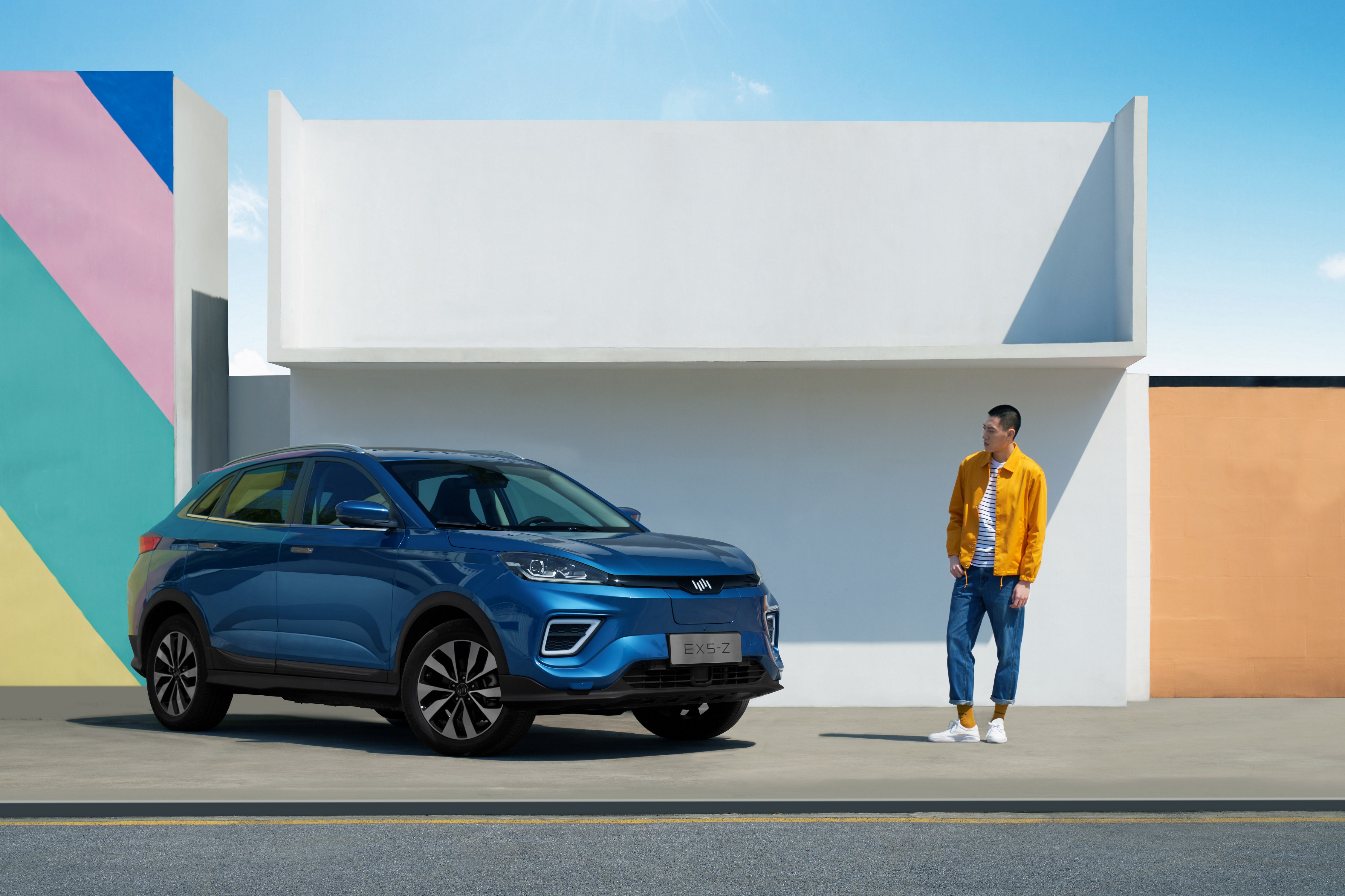 Weltmeister EX5-Z Crossover parked near colorful wall with man HD Wallpaper