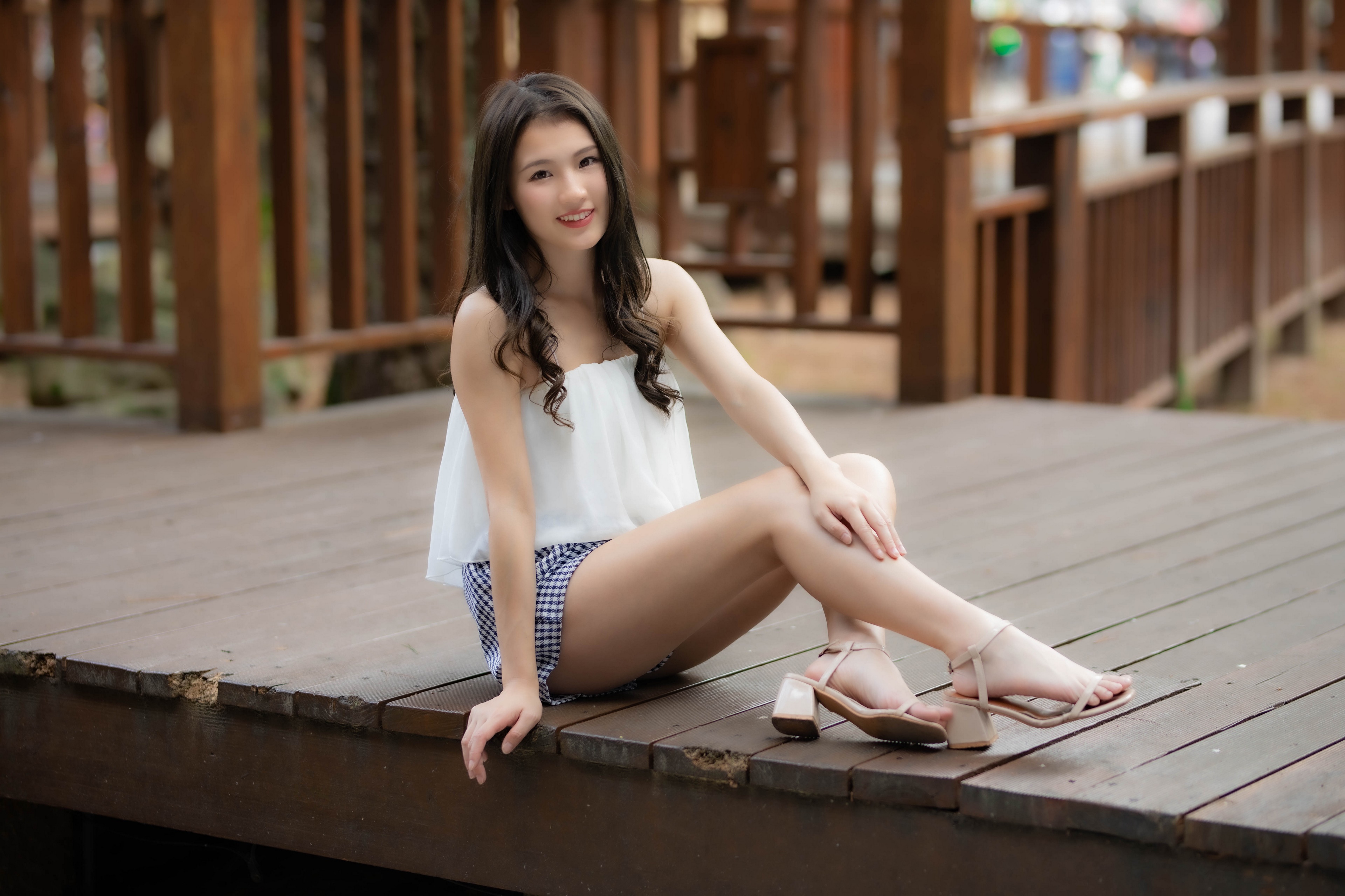Asian woman sitting on wooden deck HD Wallpaper