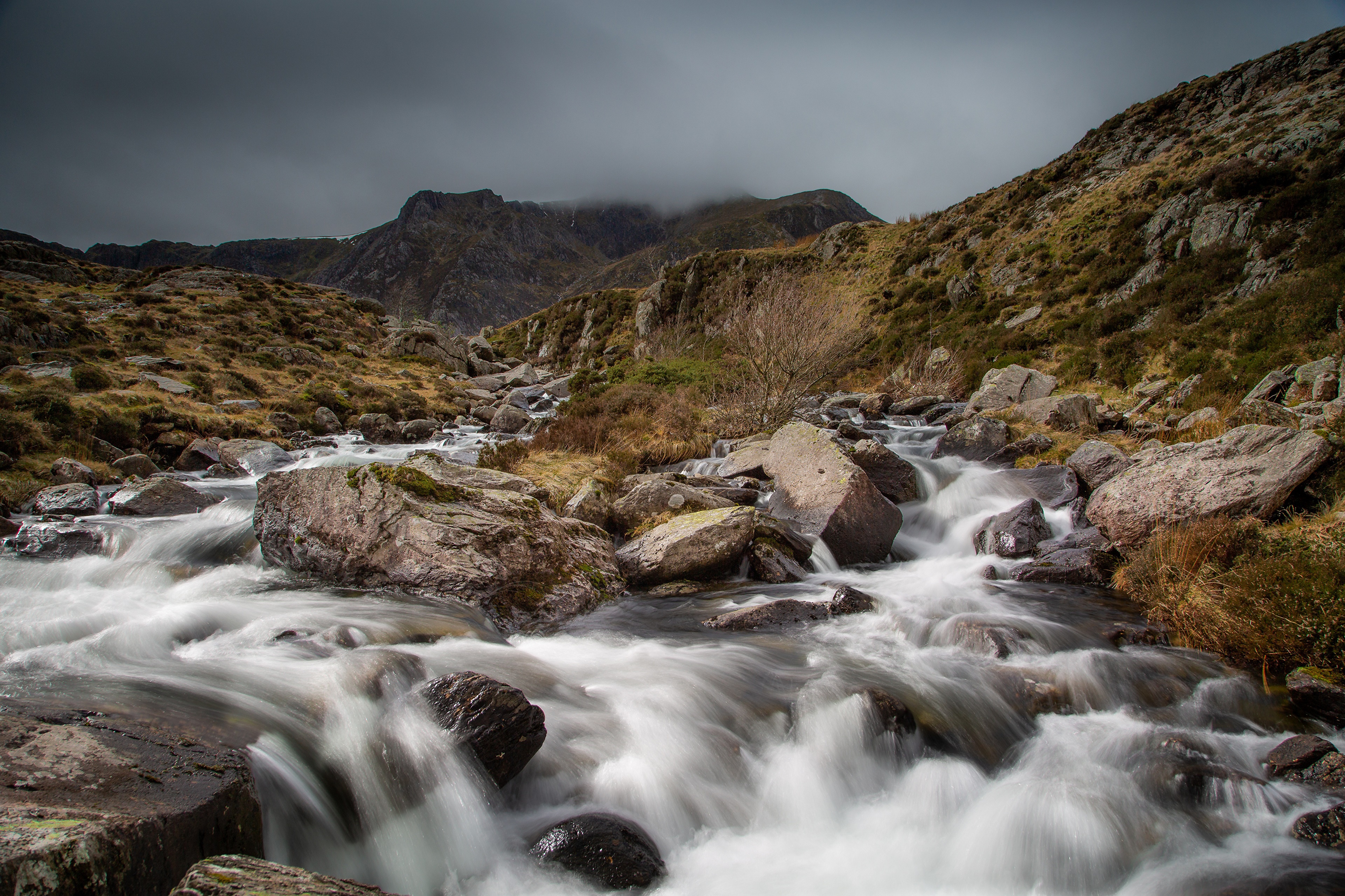 River flowing through rocky terrain in Snowdonia, Wales HD Wallpaper