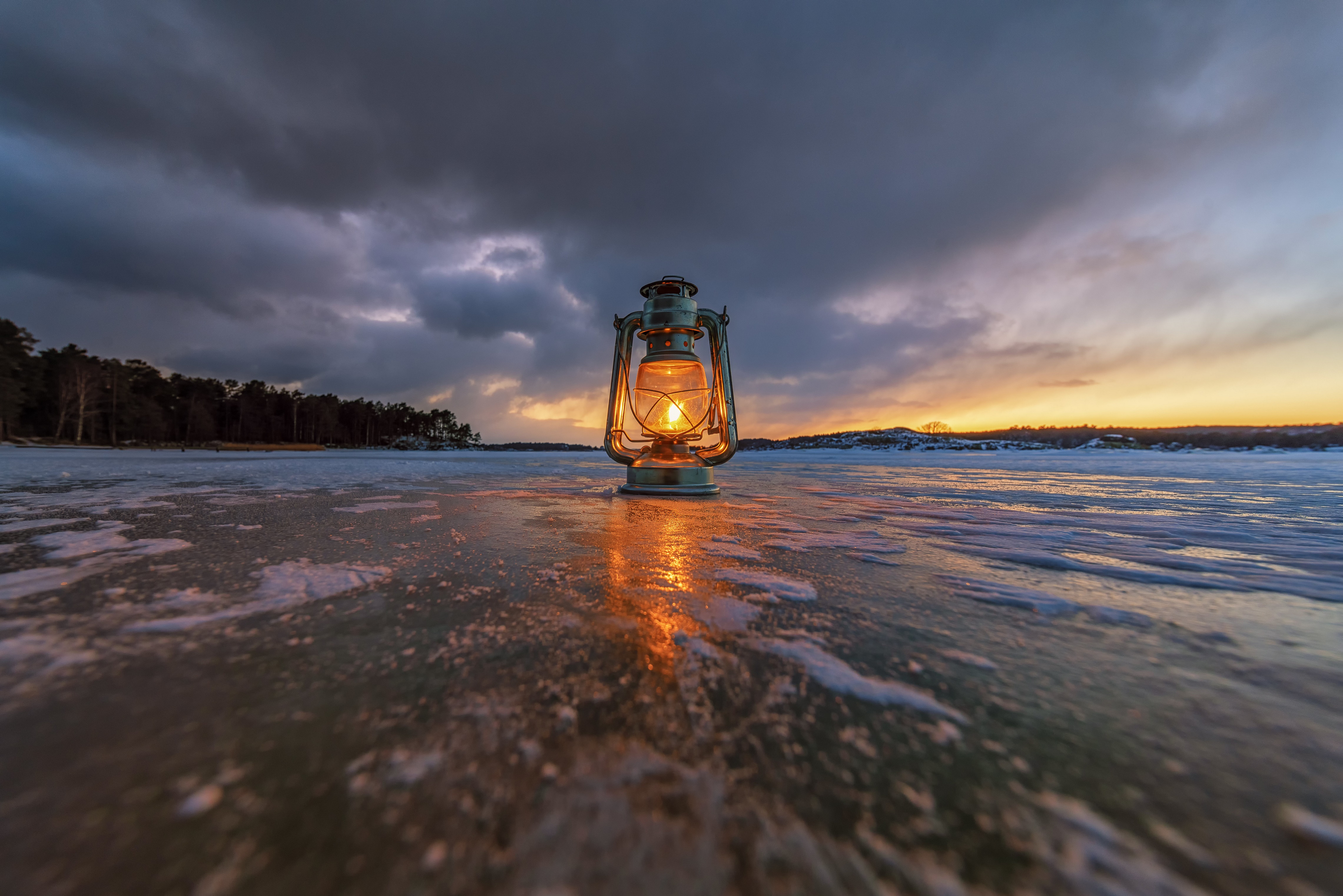 Kerosene lamp on ice at sunset HD Wallpaper