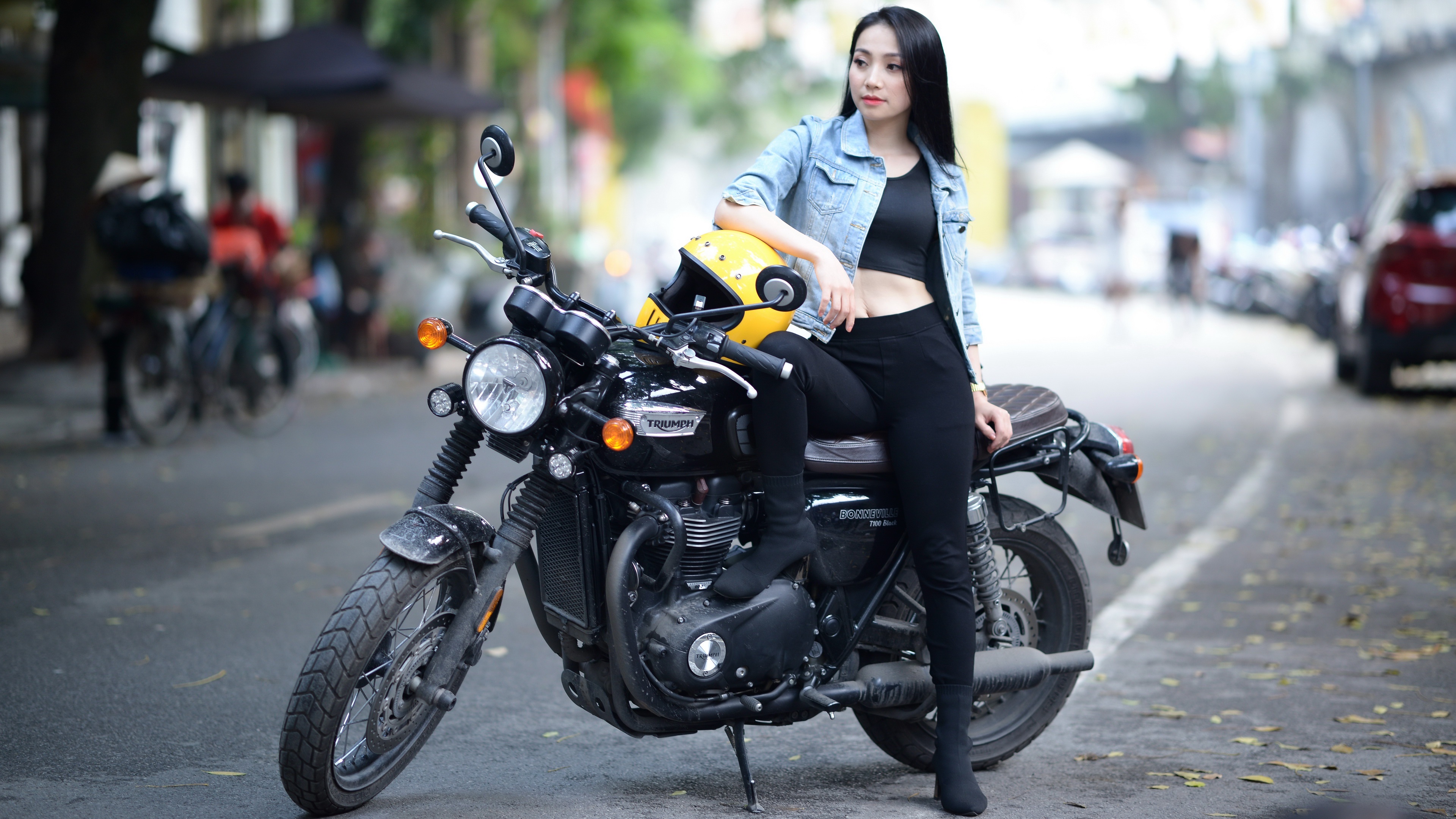 Asian woman with Triumph Bonneville T100 motorcycle HD Wallpaper