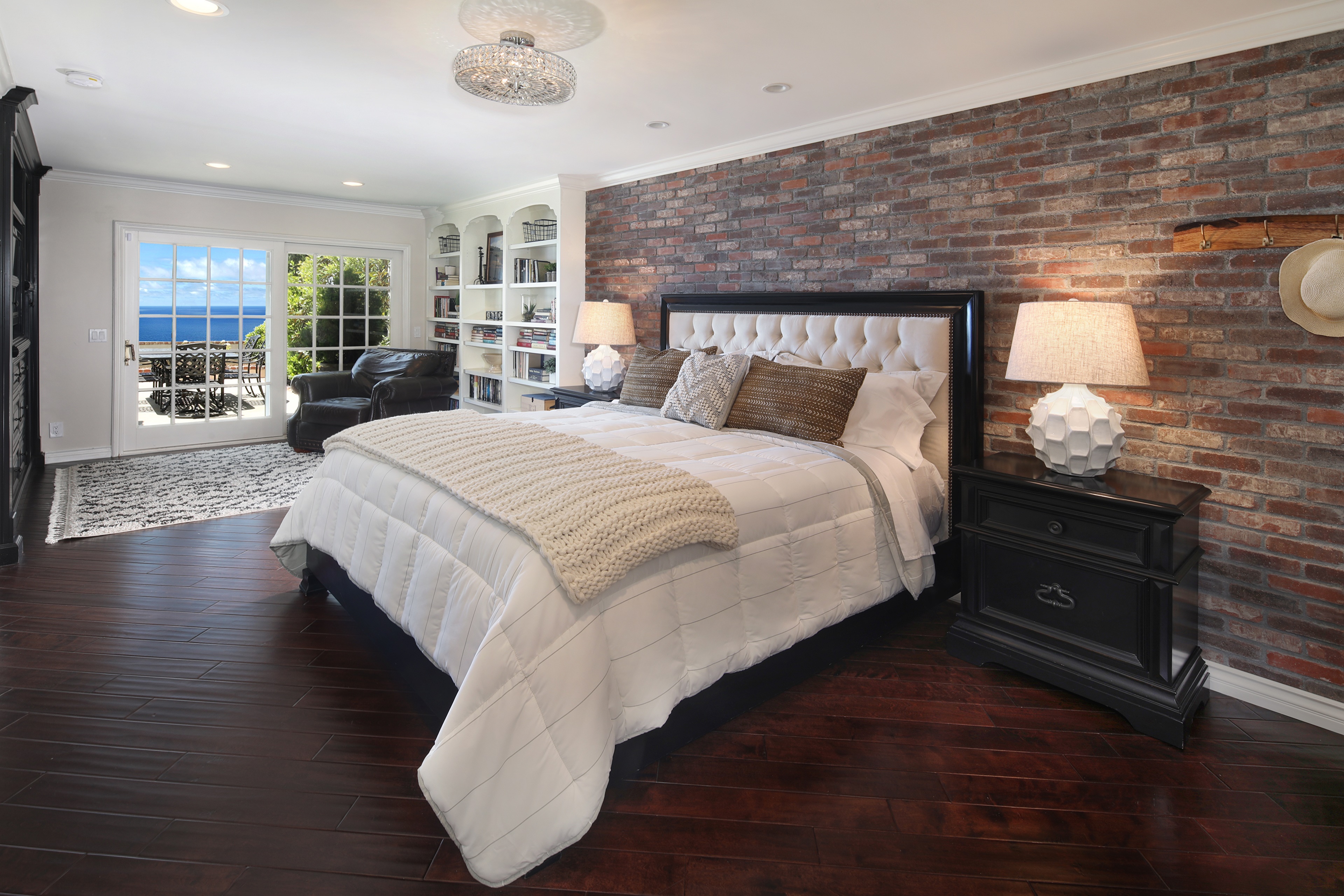 Bedroom with brick wall and ocean view HD Wallpaper