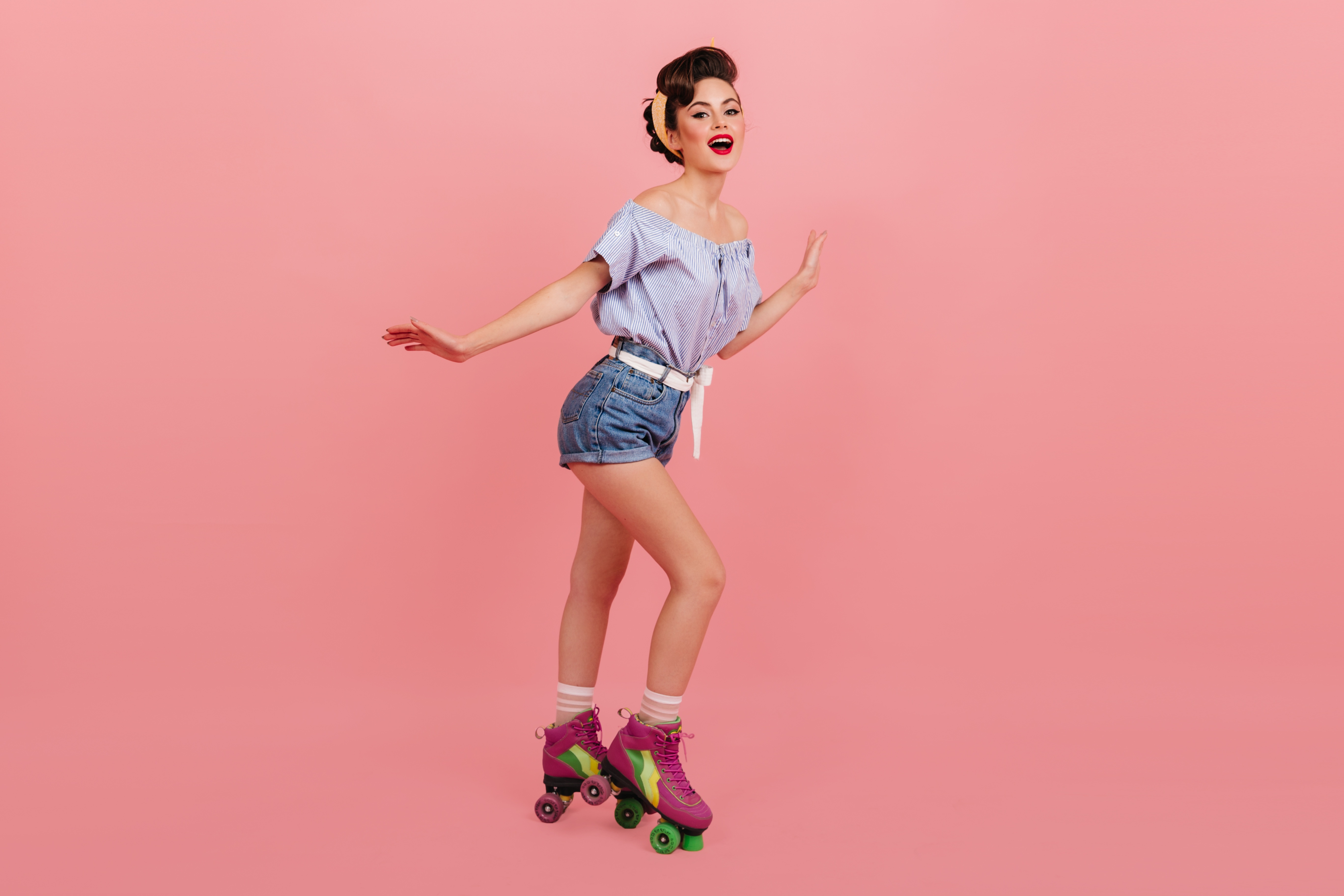 Woman with roller skates and shorts on pink background HD Wallpaper